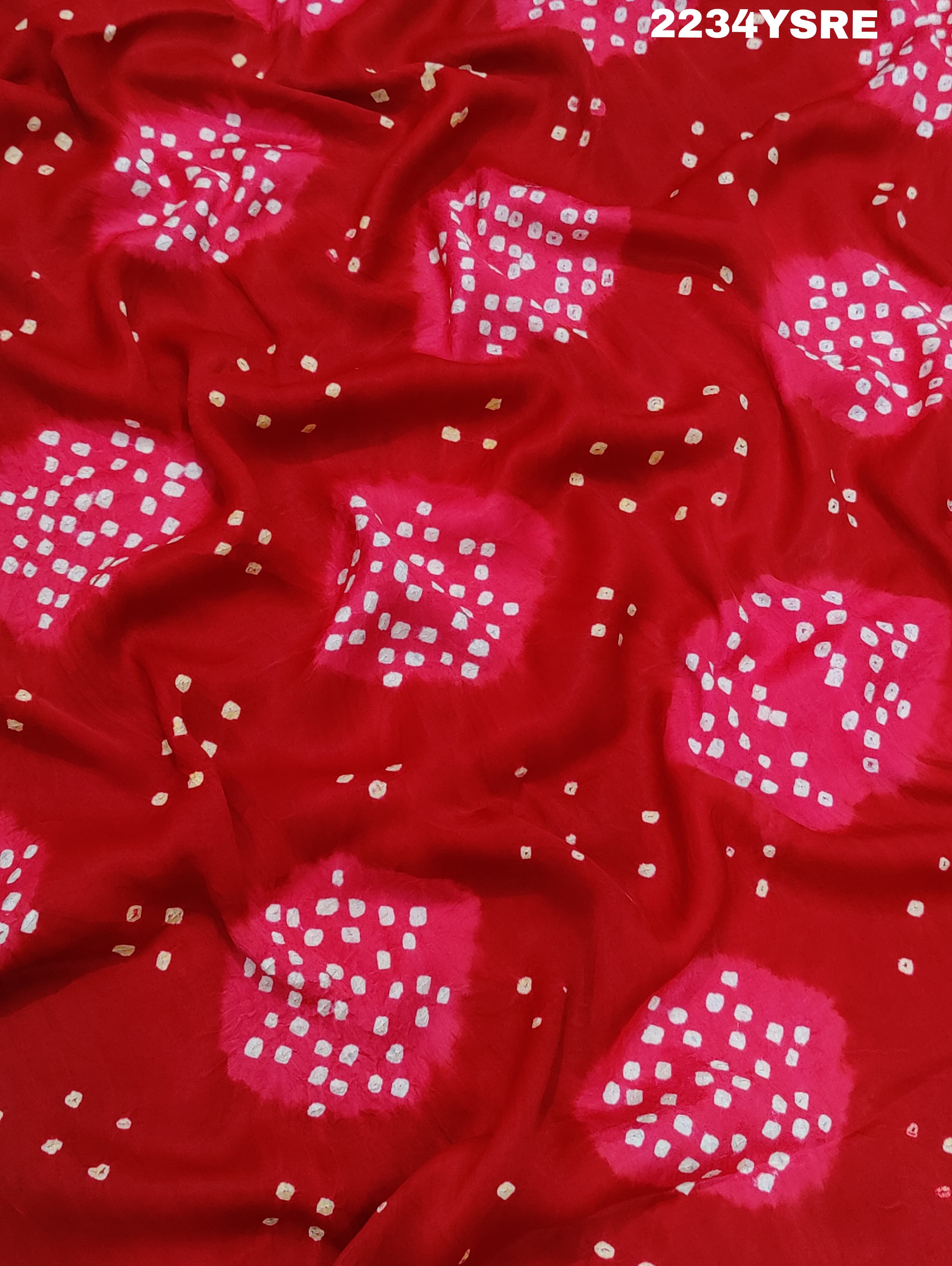 A red and white bandhani style saree