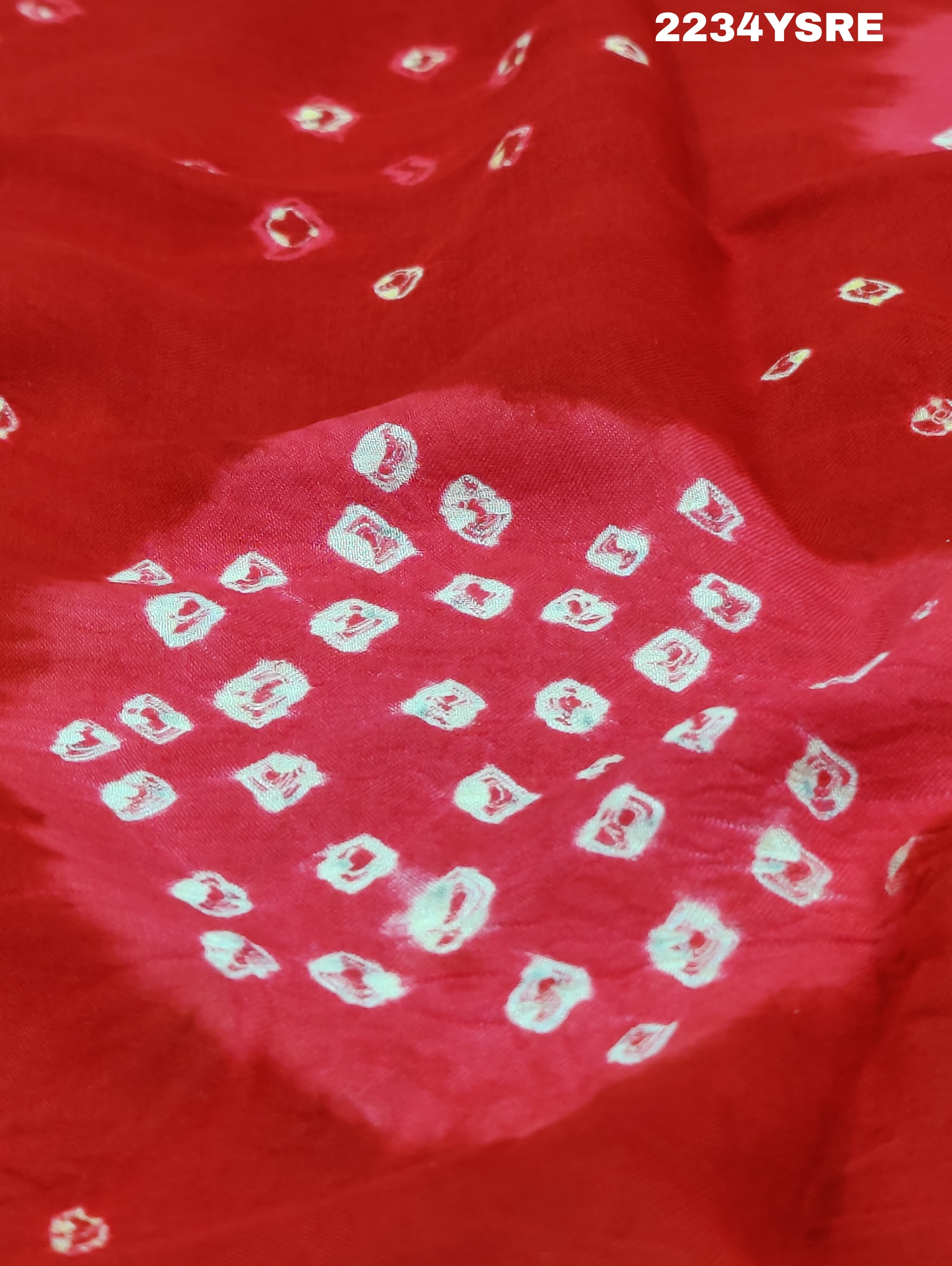 A red and white bandhani style saree