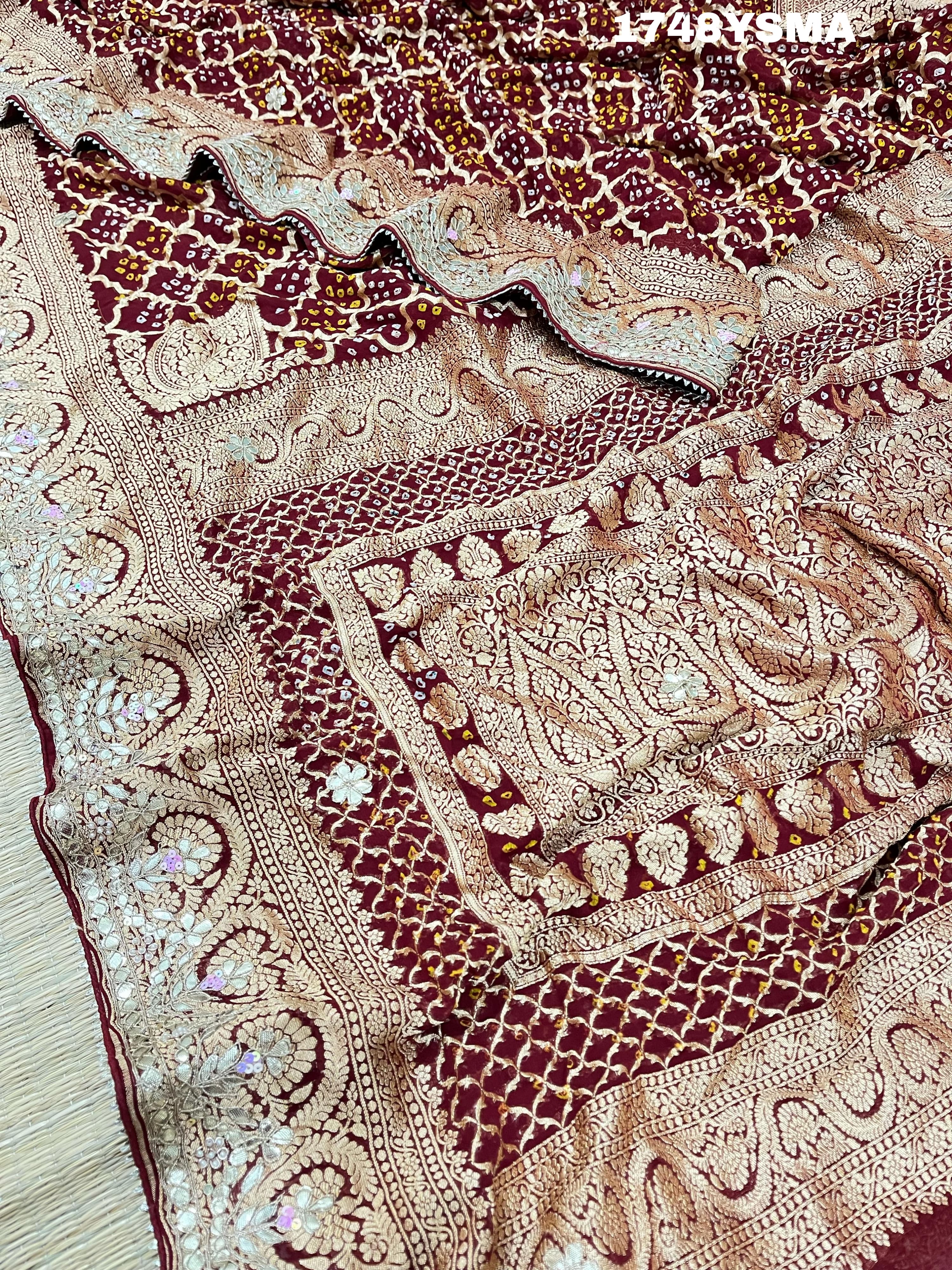 A maroon and gold saree withbandhej patterns and gotapatti handwork.