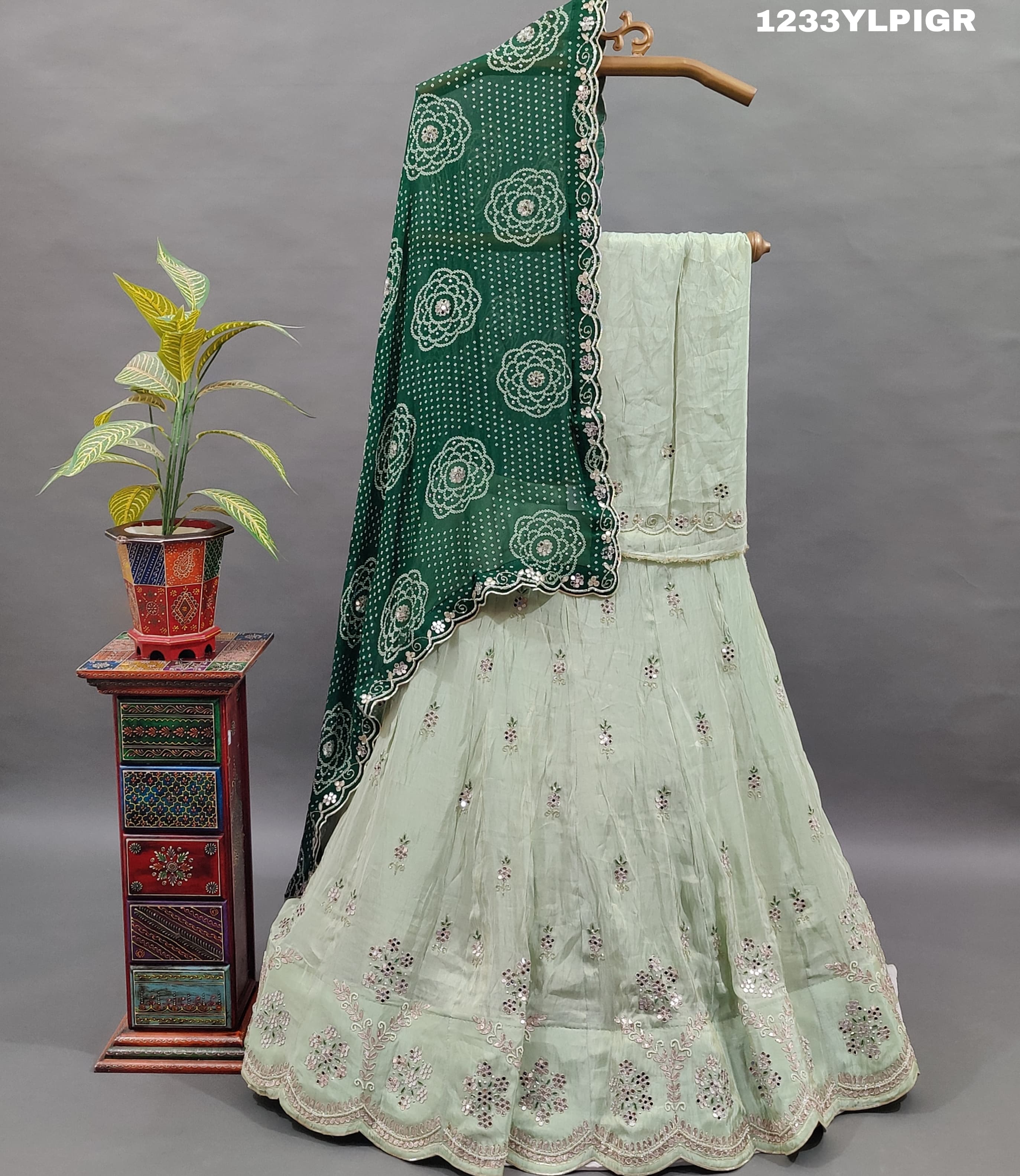 A traditional Indian lehenga set with mirror and gotapatti work