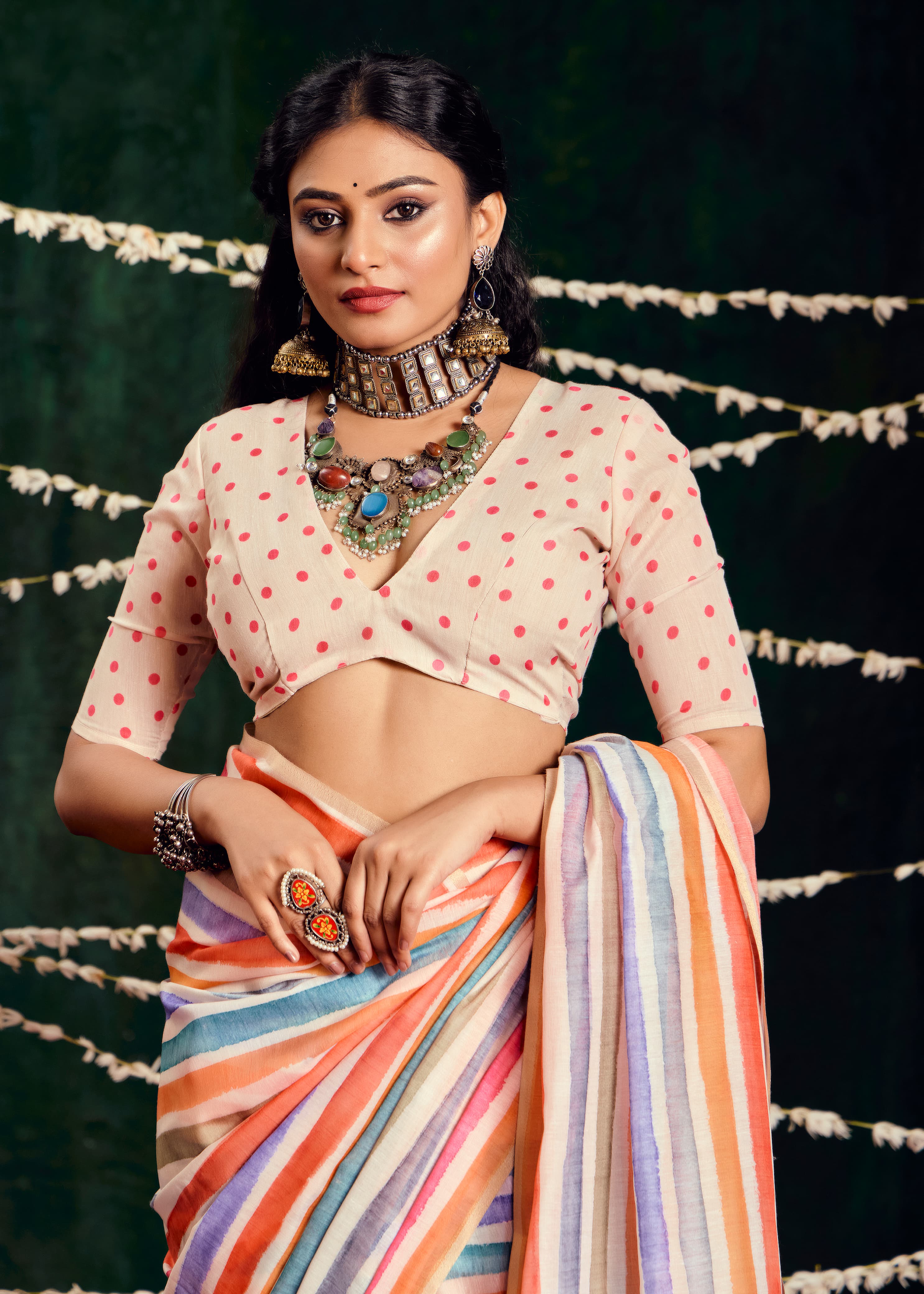 A multicolored cotton silk printed Bollywood saree with a traditional design, featuring stripes and floral patterns