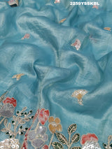 A blue saree with tissue silk fabric and Bollywood-style sequence embroidery work, including floral patterns and a border.