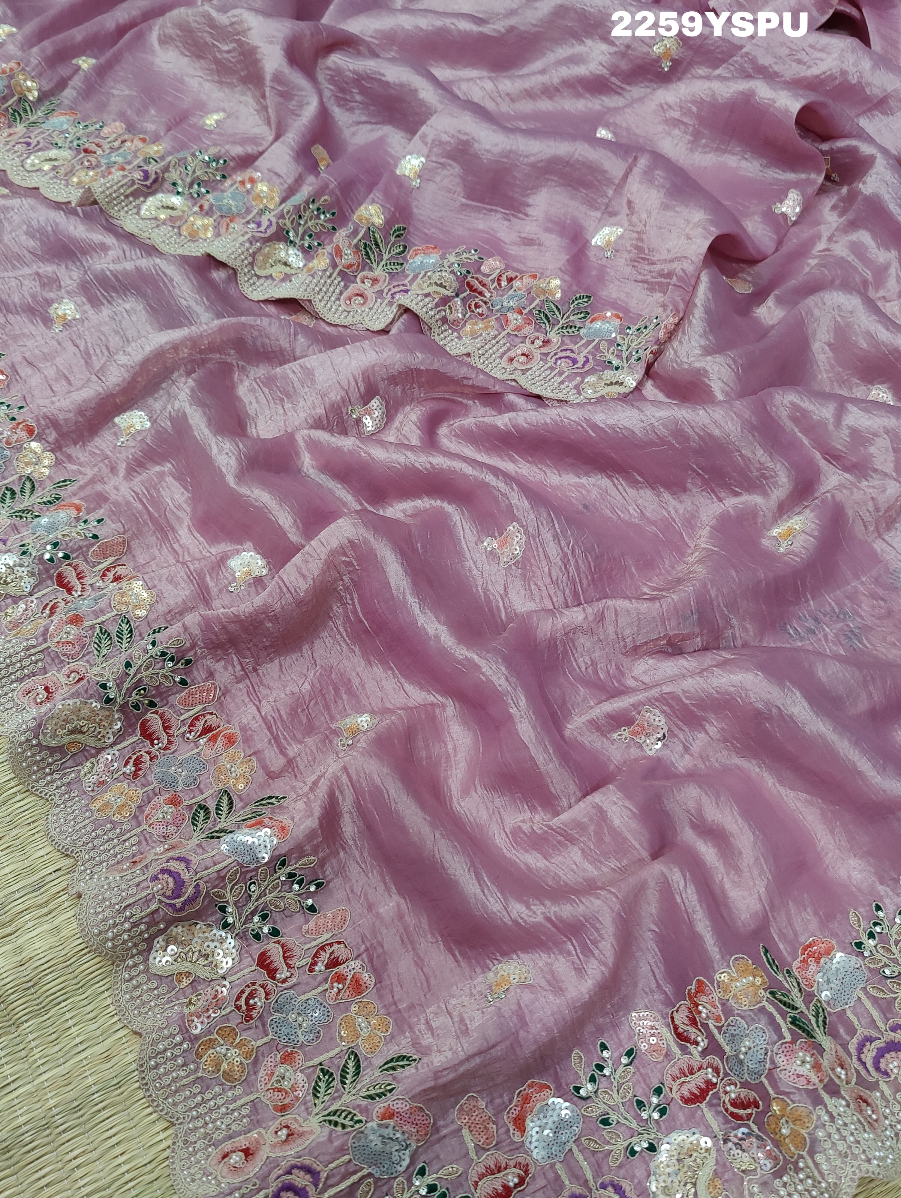 A purple tissue silk saree with Bollywood-style sequence embroidery work, suitable for traditional and party wear.