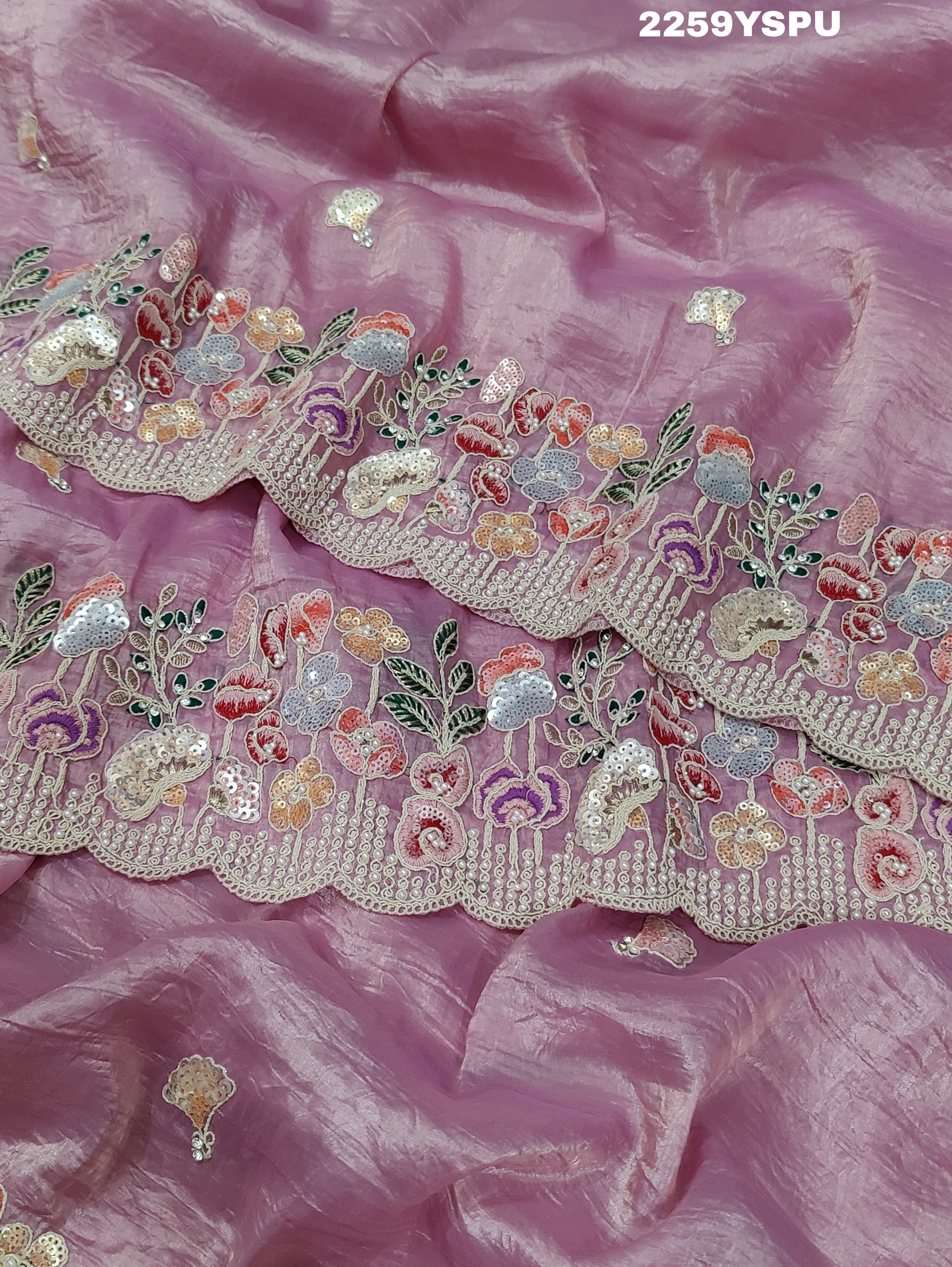 A purple tissue silk saree with Bollywood-style sequence embroidery work, suitable for traditional and party wear.