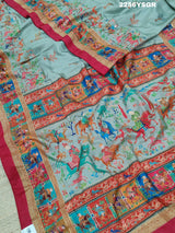 A cotton silk saree with a kalamkari style foil print design featuring multiple colors including red, green, and beige.