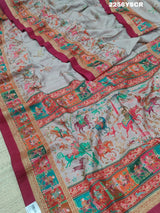 A cotton silk saree with a kalamkari style foil print design in multiple colors including cream, red, and green.