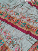 A cotton silk saree with a kalamkari style foil print design in multiple colors including cream, red, and green.