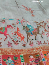 A cotton silk saree with a kalamkari style foil print design in multiple colors including cream, red, and green.
