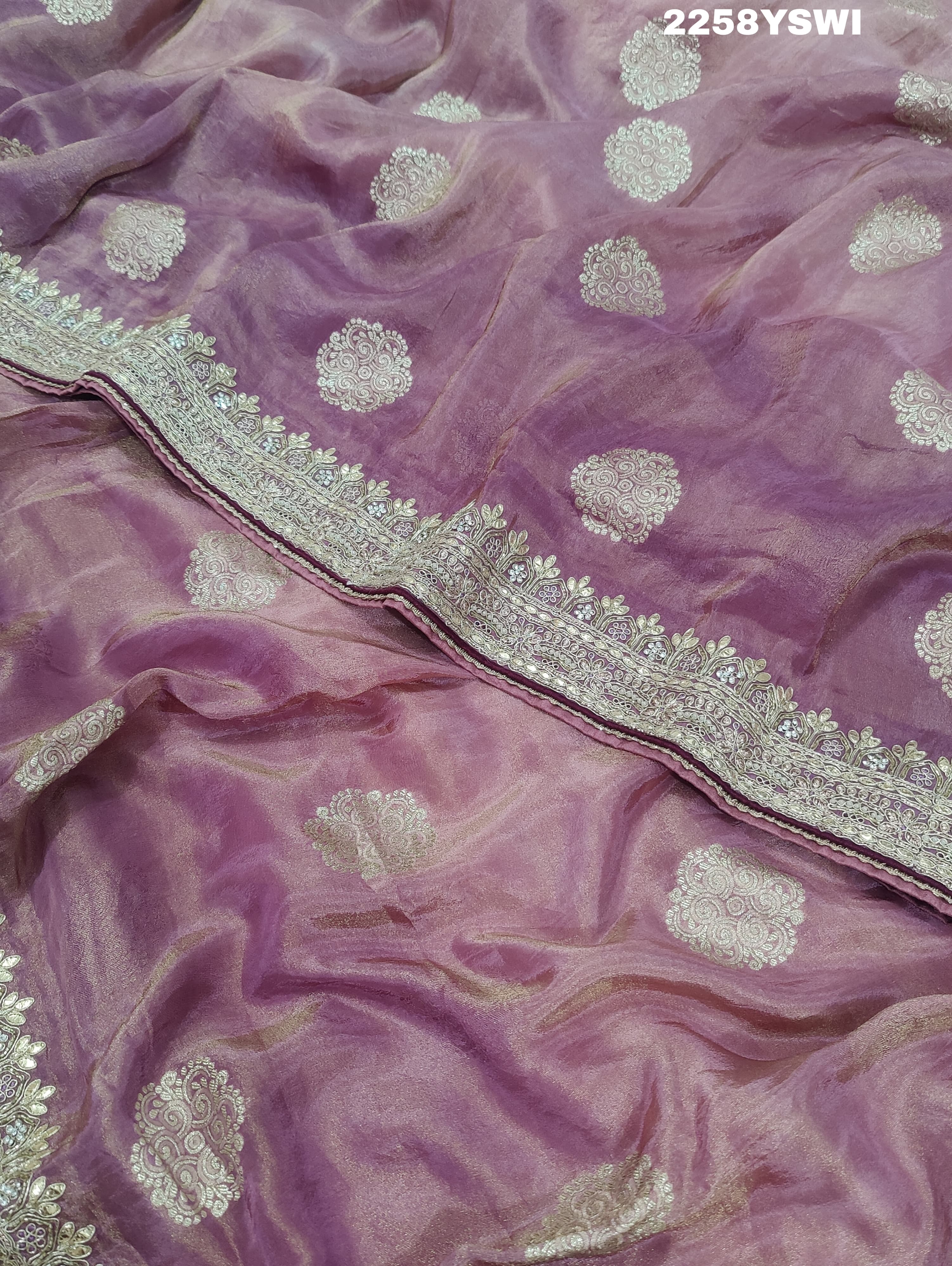 A purple Banarasi silk saree with Bollywood-style embellishments including sequins and gotapatti work,