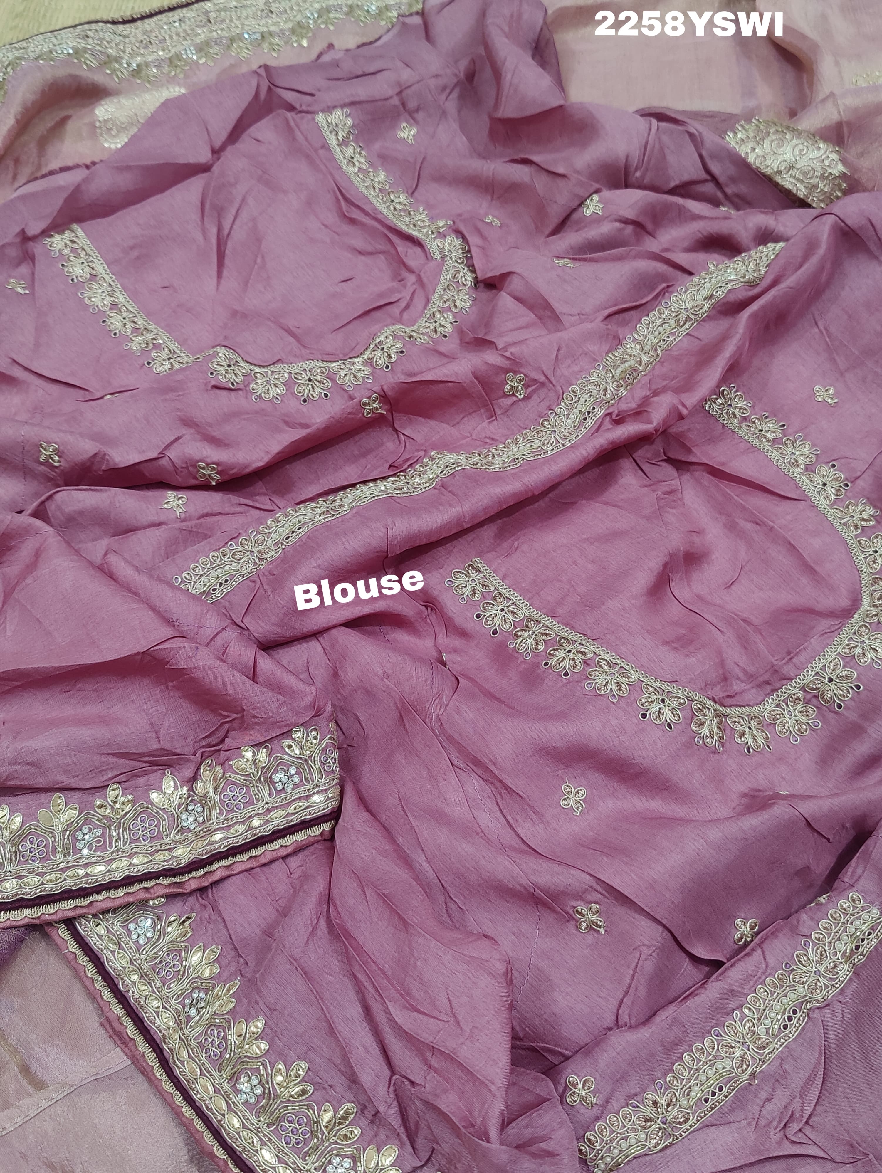A purple Banarasi silk saree with Bollywood-style embellishments including sequins and gotapatti work,
