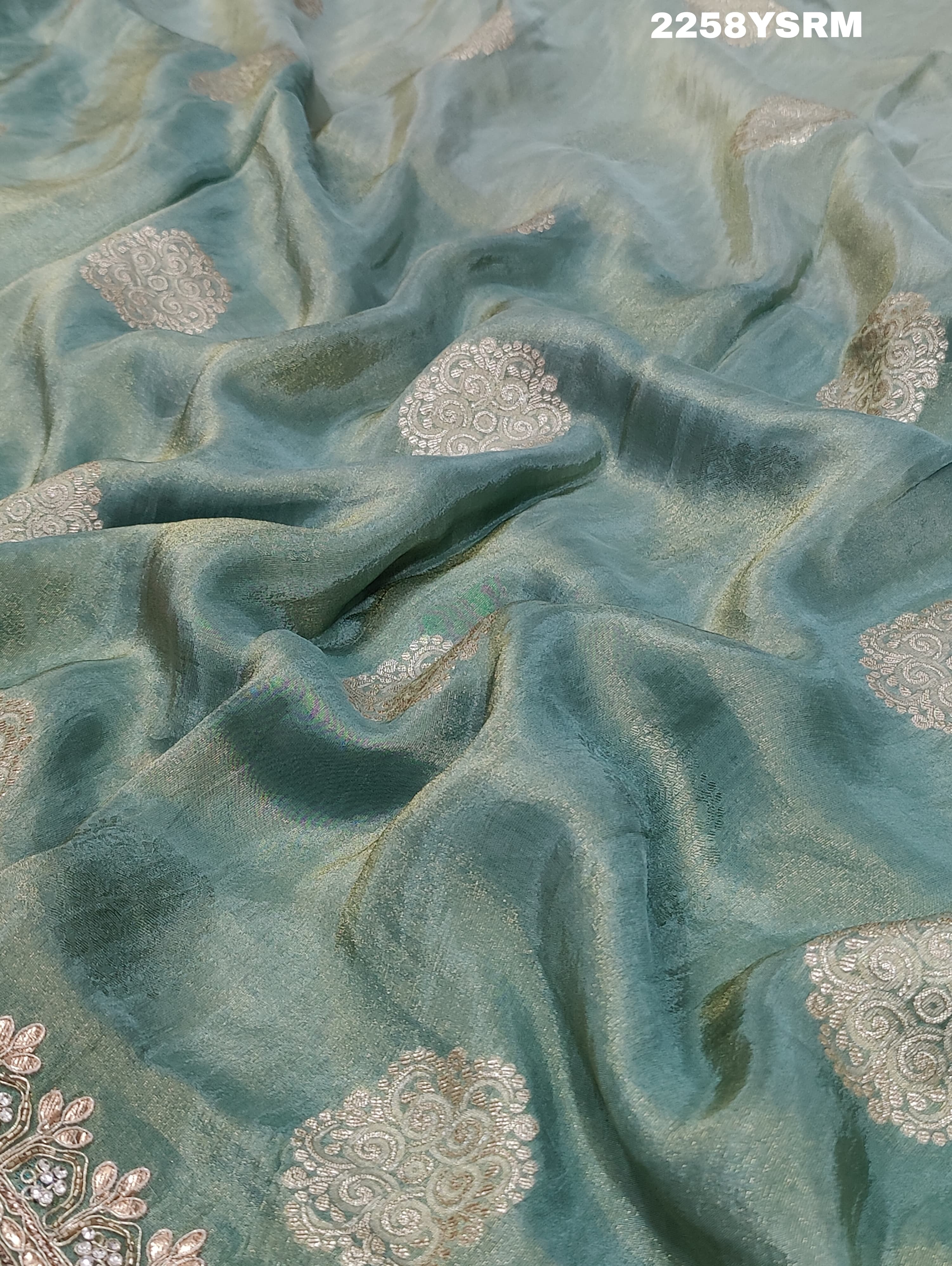 A sea green Banarasi silk saree with Bollywood style embellishments including sequins and gotapatti work