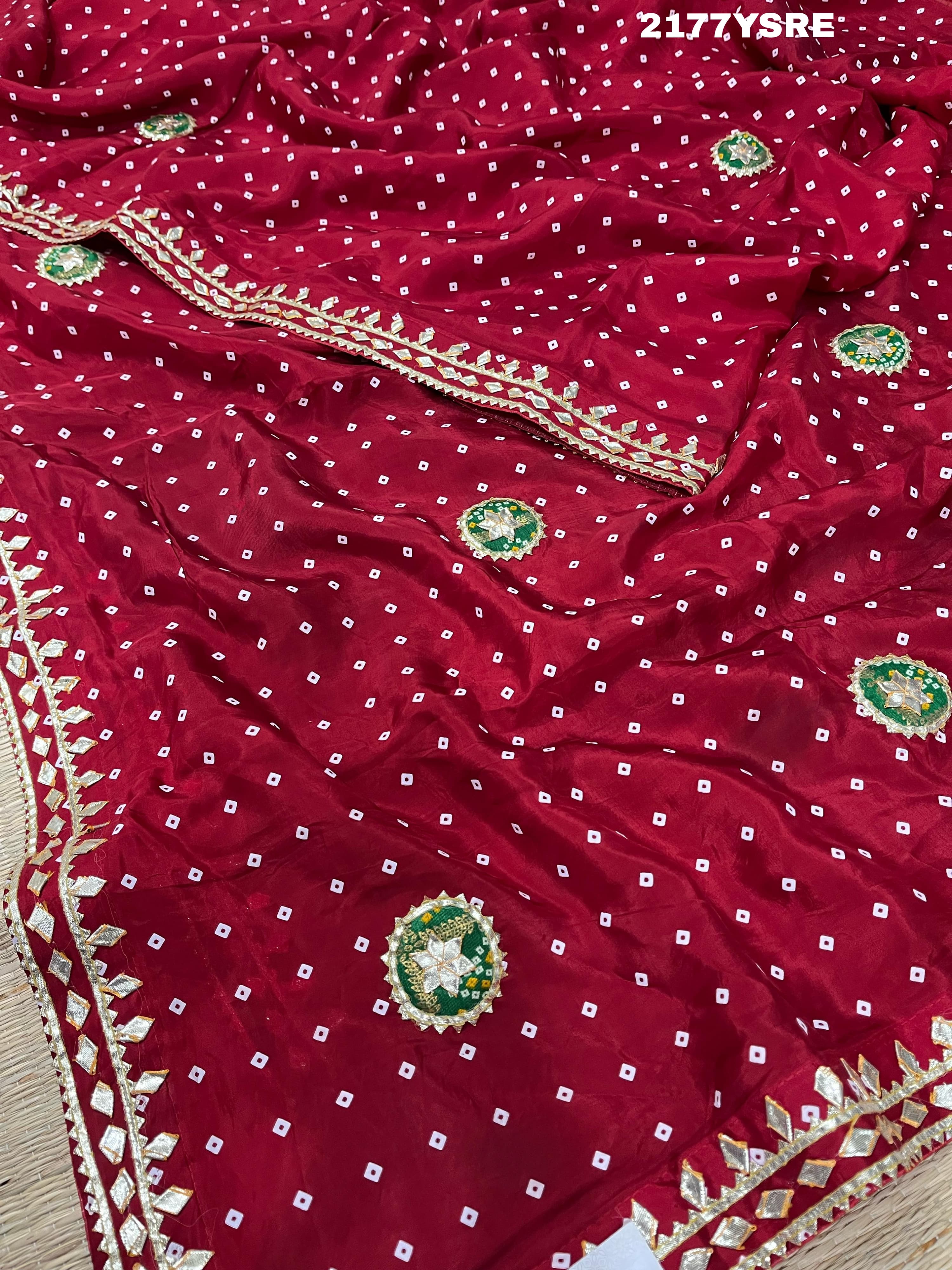 A red and blue modal silk bandhani saree with kachha gotapatti work, including intricate patterns and designs.