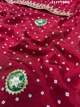 A red and blue modal silk bandhani saree with kachha gotapatti work, including intricate patterns and designs.