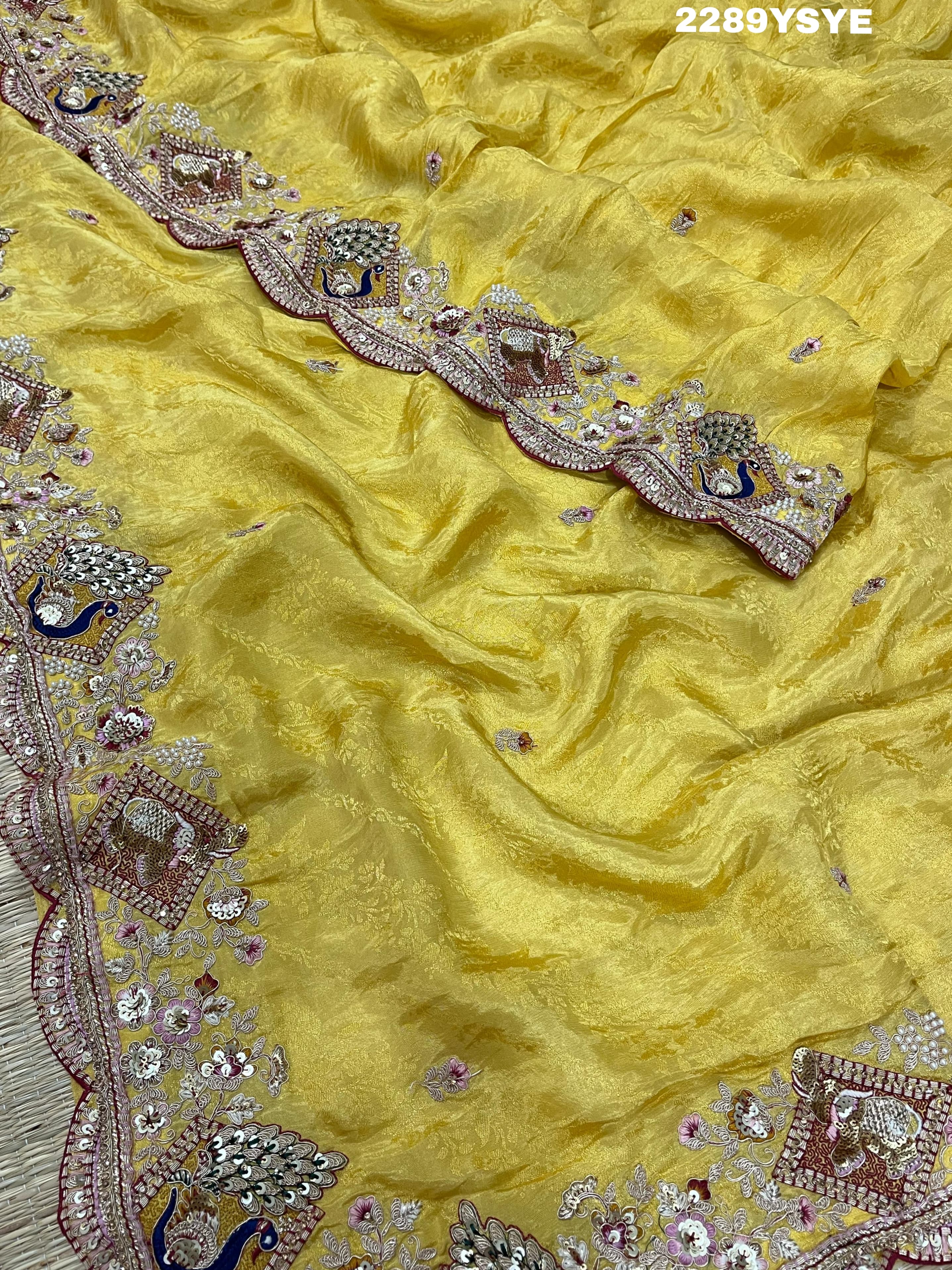 A yellow Banarasi silk saree with Bollywood style embellishments including sequins and a distinctive pattern.
