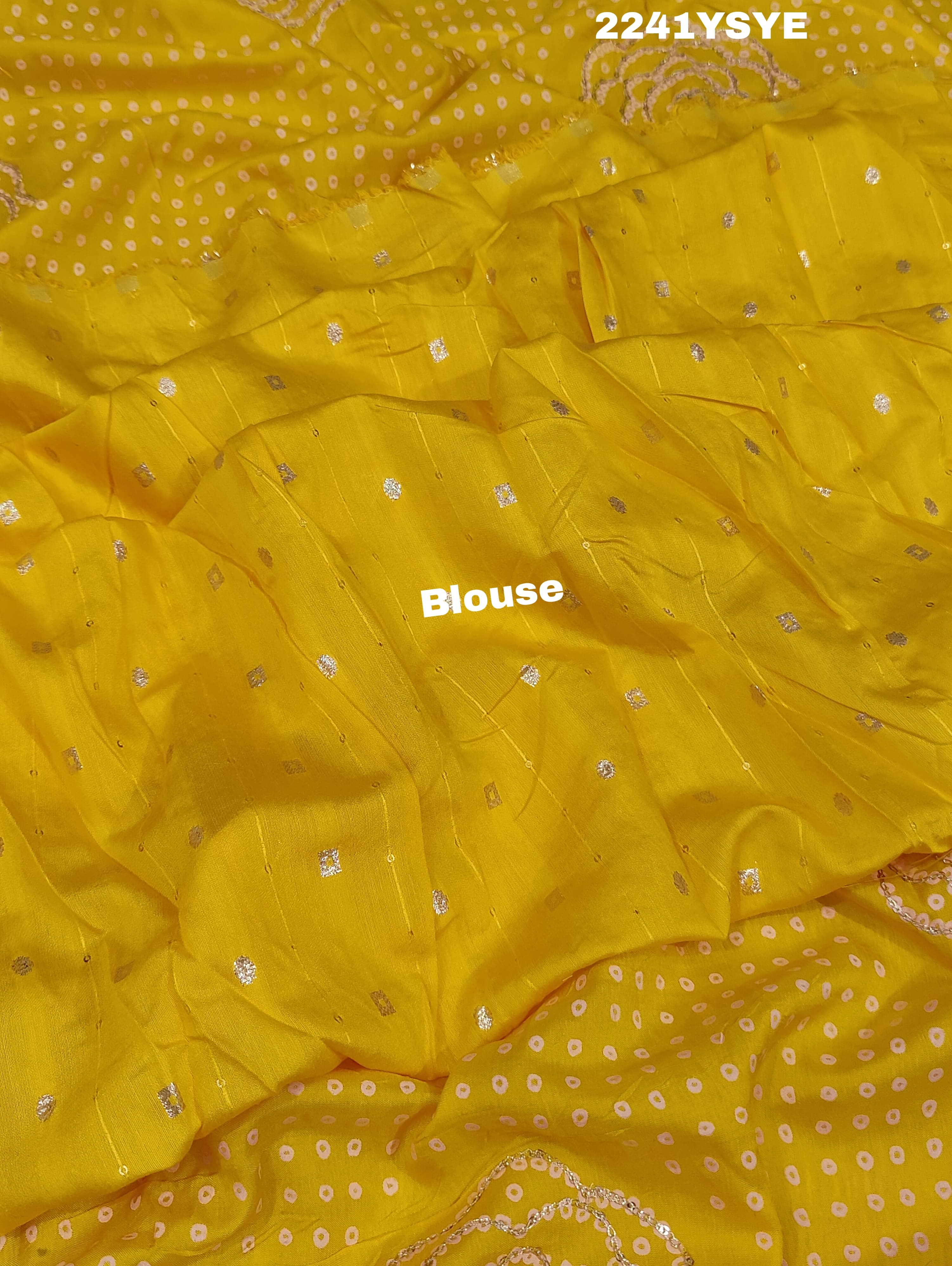 A yellow saree with bandhani style embellishments and zari work