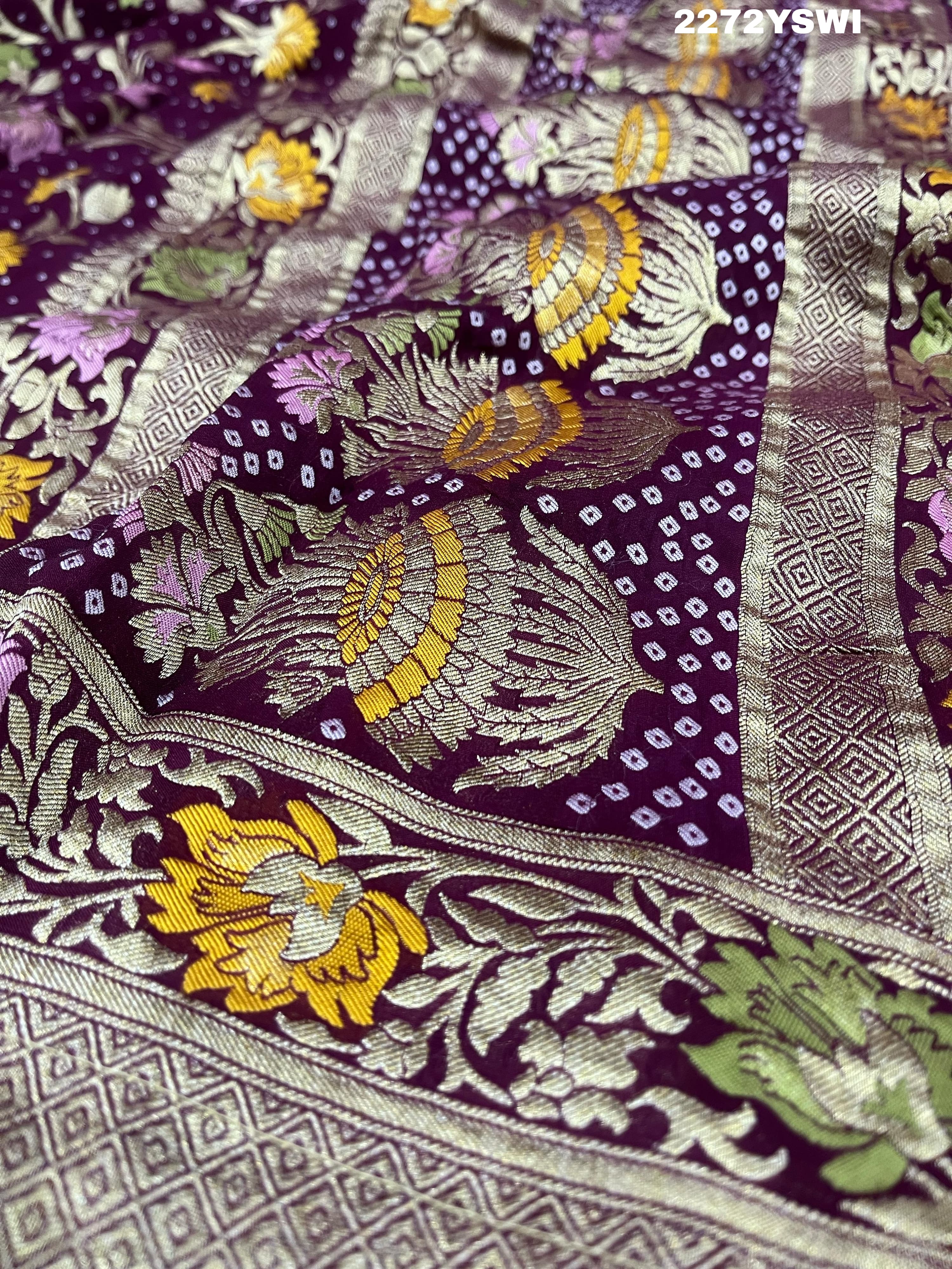 A purple georgette saree with a Meenakari weaving pattern, showing detailed floral designs and a border.
