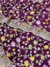 A purple georgette saree with a Meenakari weaving pattern, showing detailed floral designs and a border.