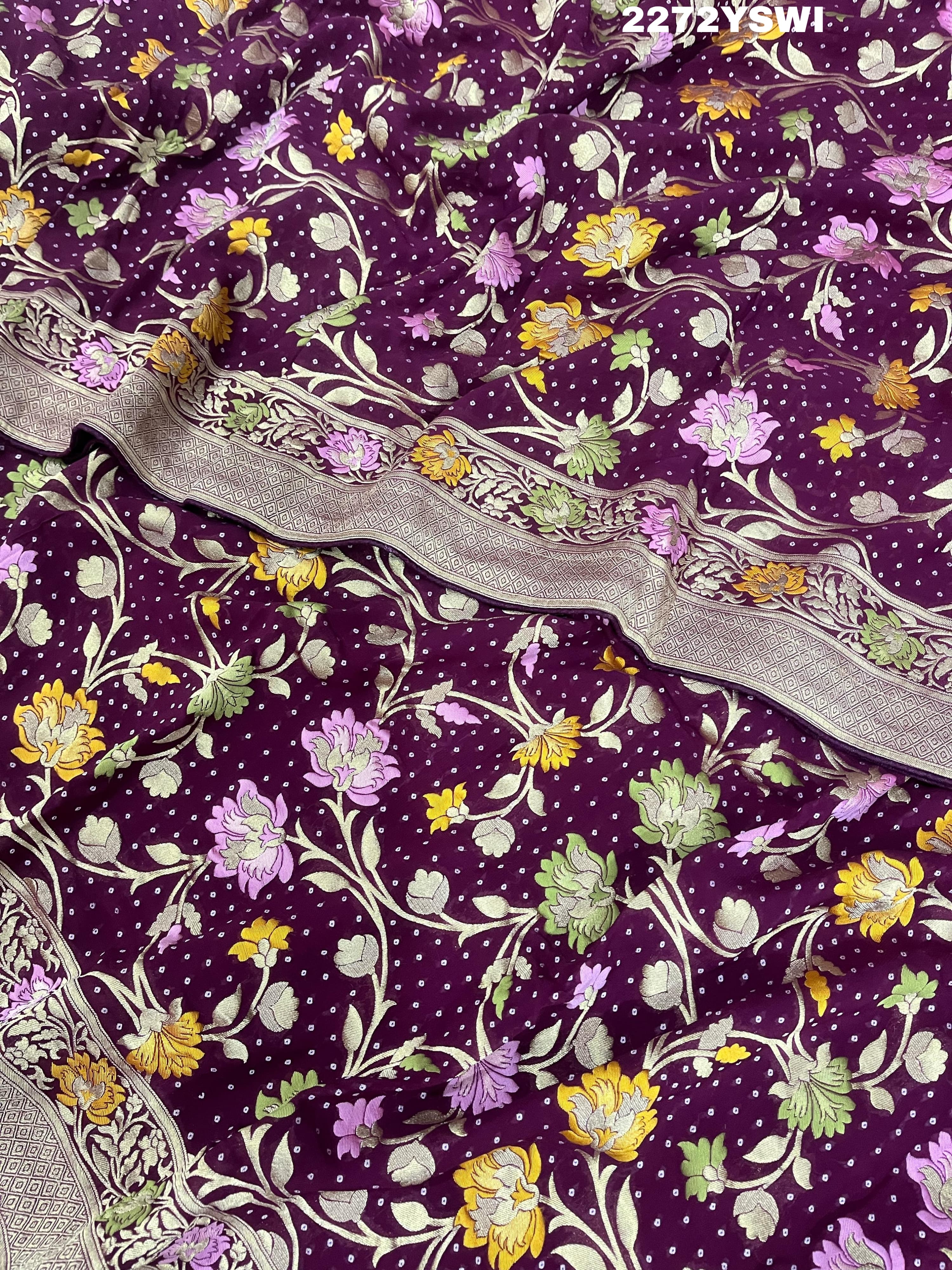 A purple georgette saree with a Meenakari weaving pattern, showing detailed floral designs and a border.