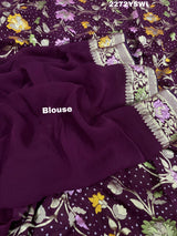A purple georgette saree with a Meenakari weaving pattern, showing detailed floral designs and a border.