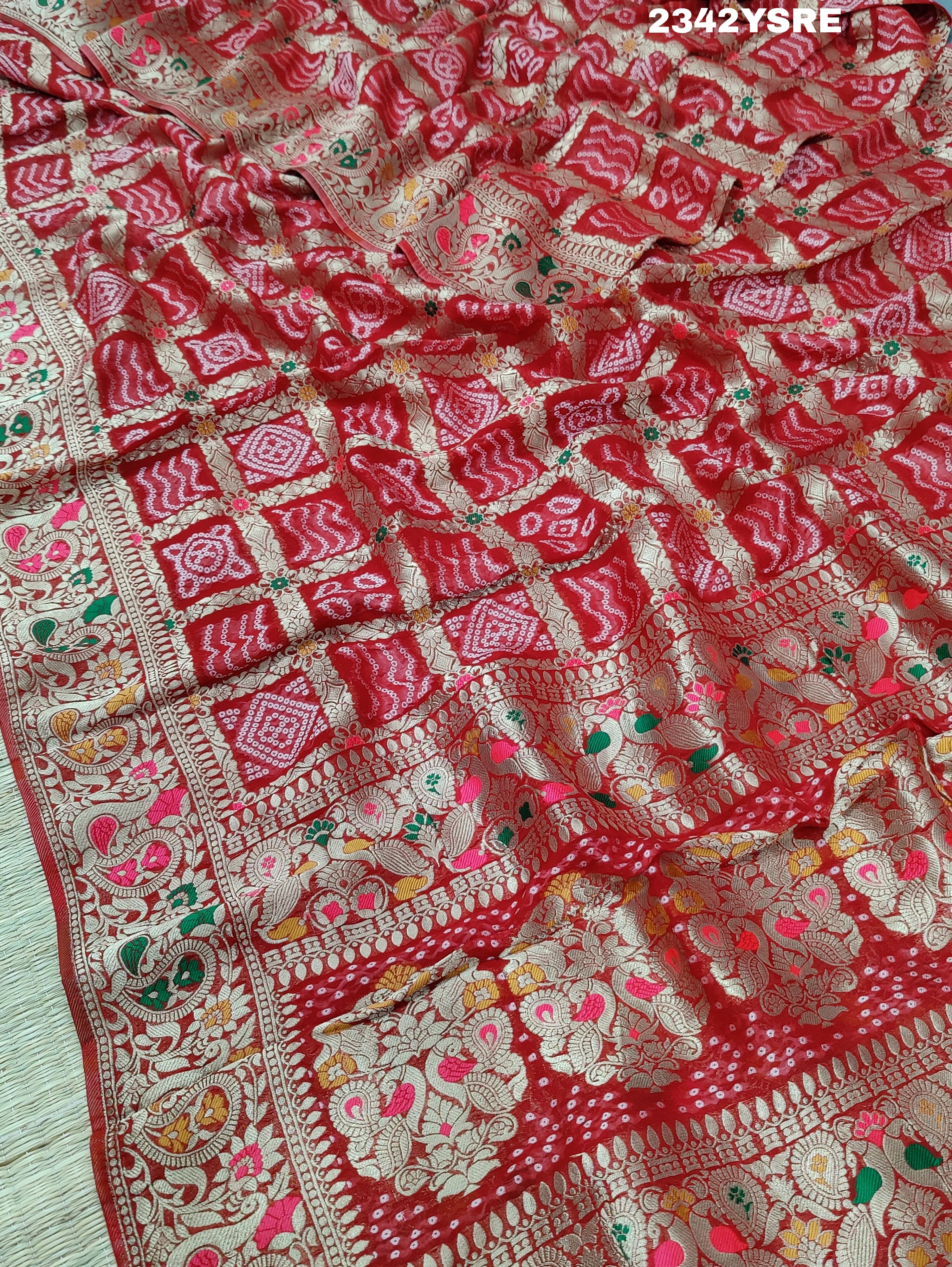 A red and gold georgette bandhani style saree with meenakari weaving,
