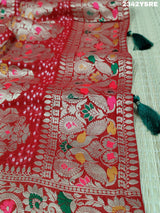 A red and gold georgette bandhani style saree with meenakari weaving,