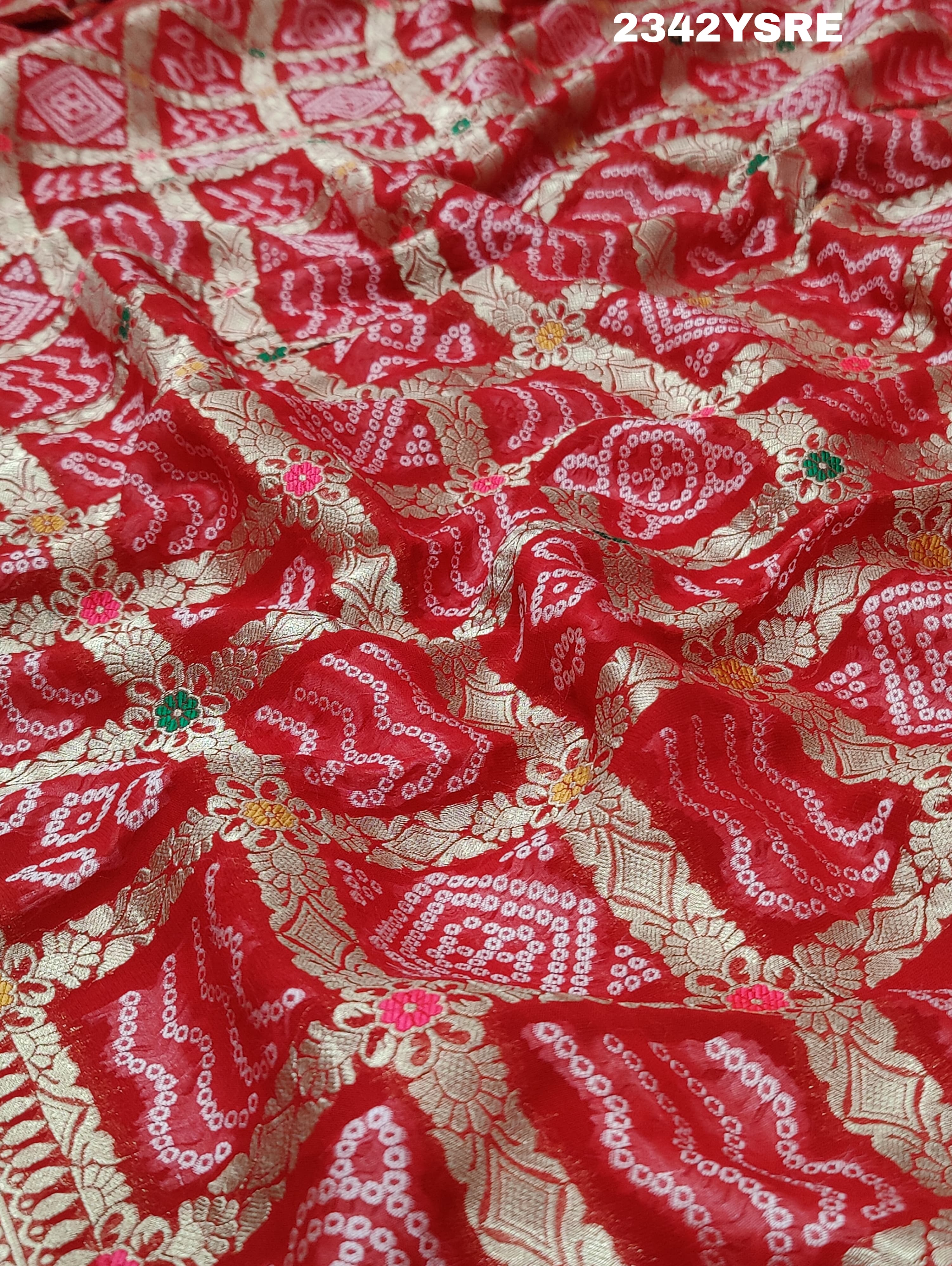 A red and gold georgette bandhani style saree with meenakari weaving,