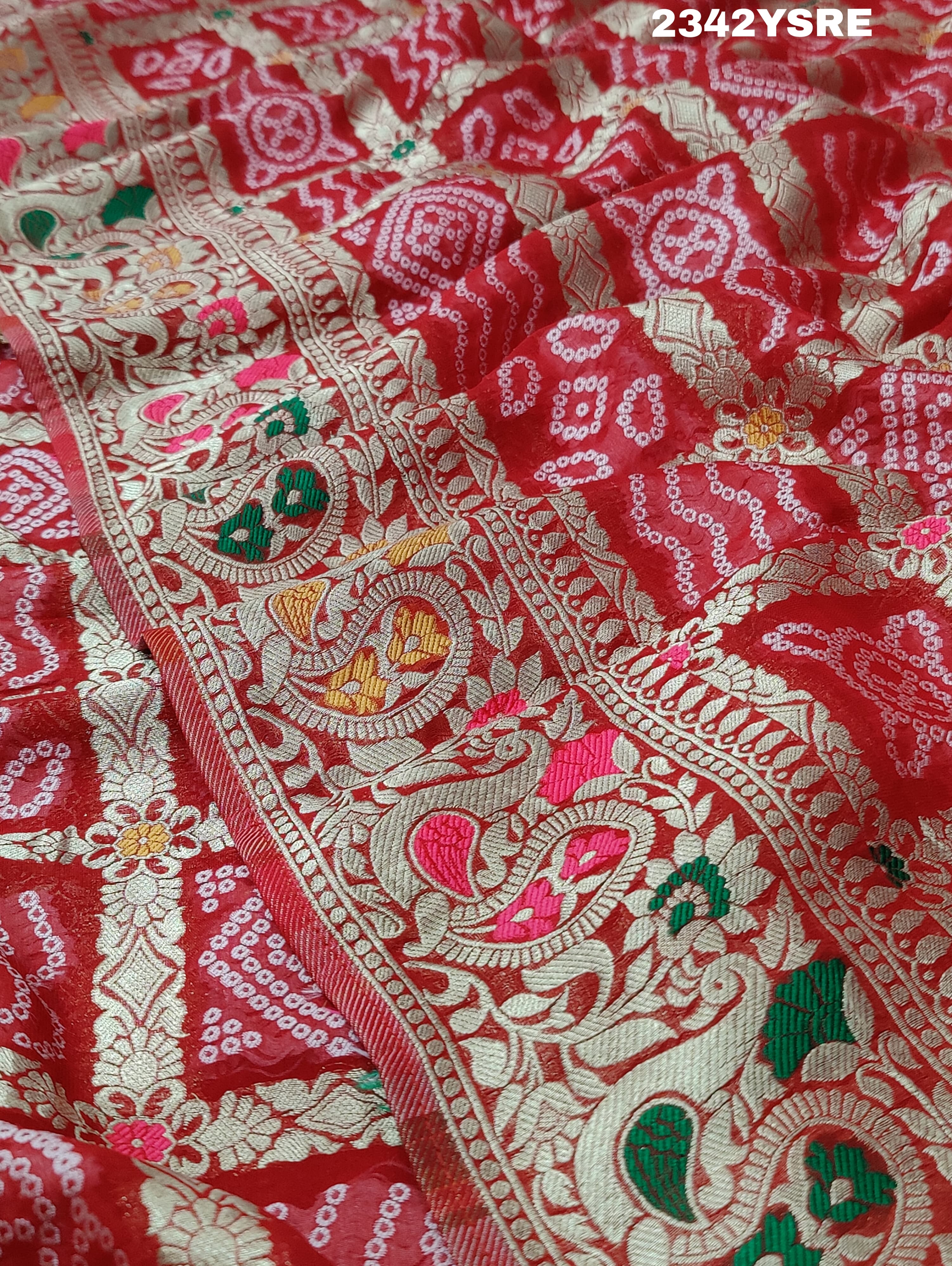 A red and gold georgette bandhani style saree with meenakari weaving,