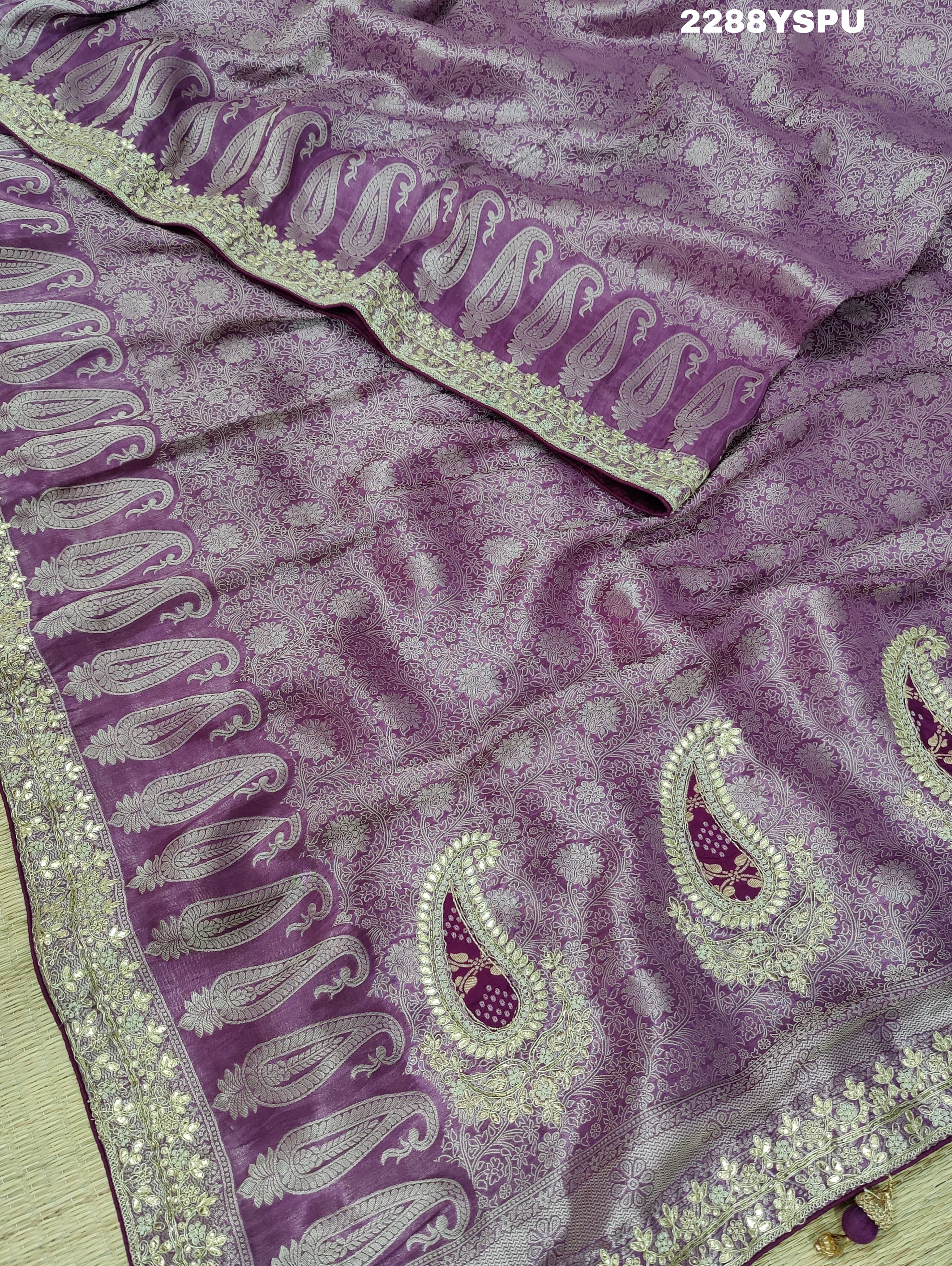 A purple Banarsi silk Bollywood style saree with sequence and gotapatti work, showing detailed patterns and embroidery.