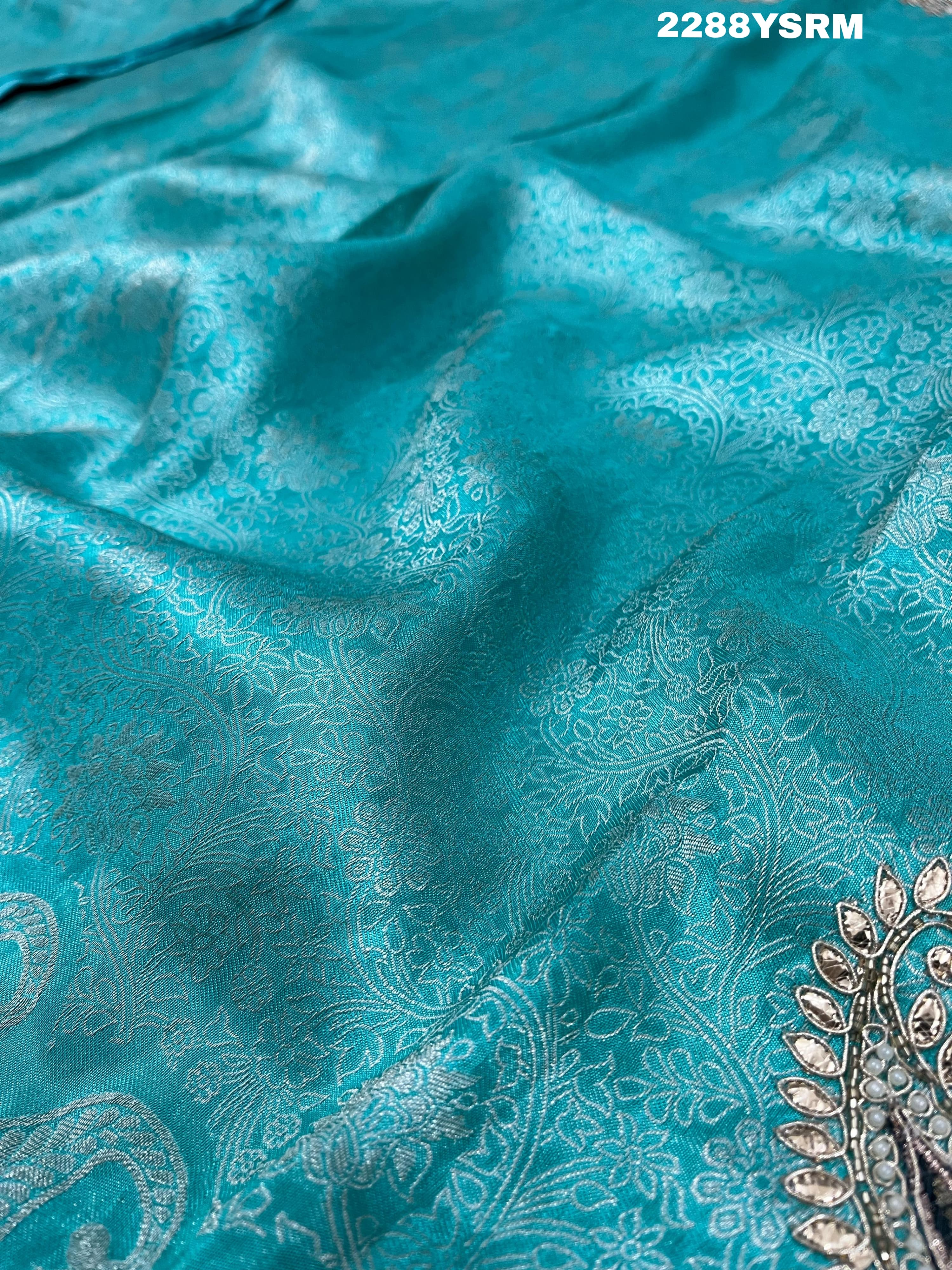 A sea green Banarsi silk Bollywood style saree with sequence and gotapatti work
