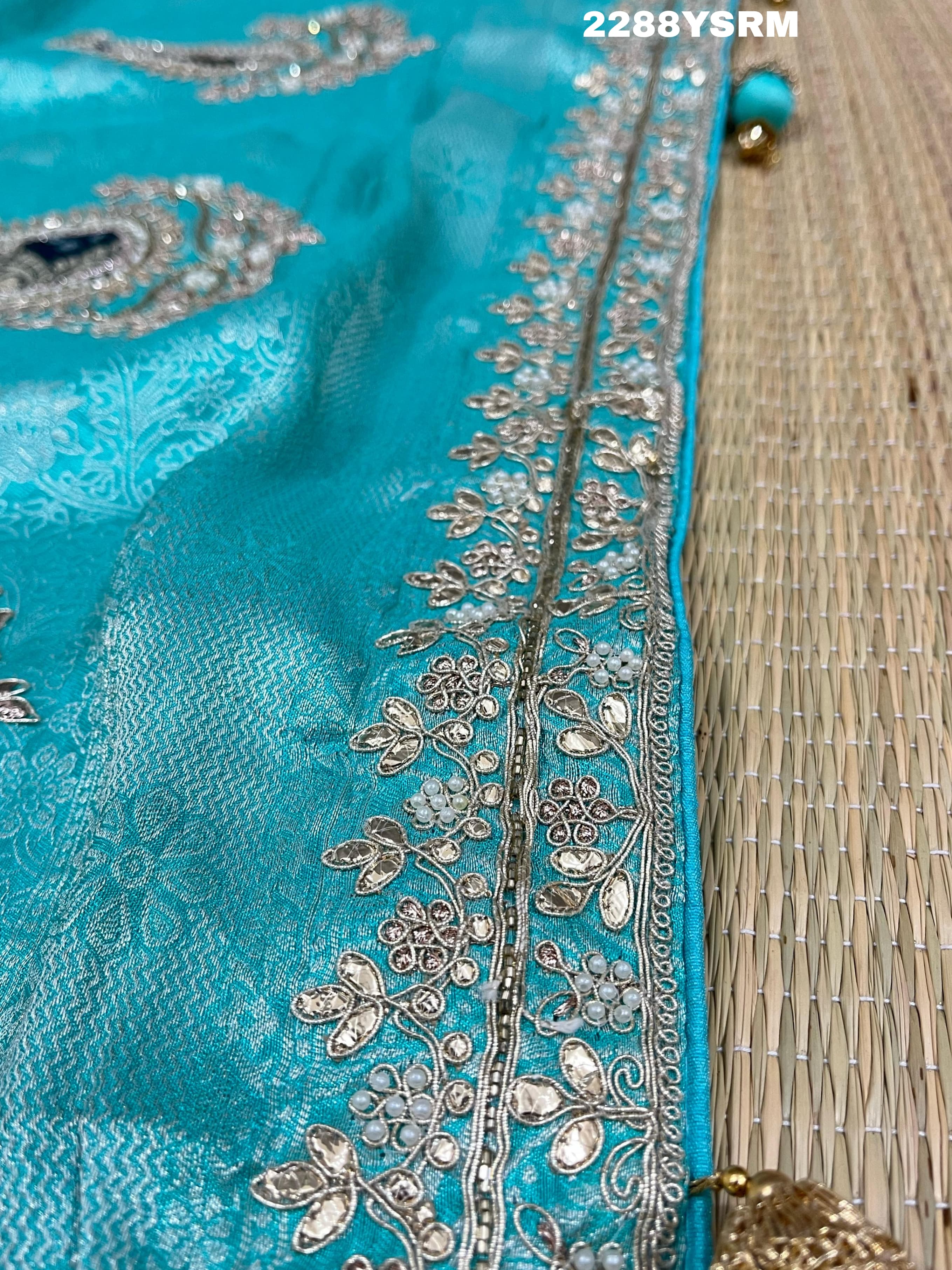 A sea green Banarsi silk Bollywood style saree with sequence and gotapatti work