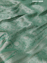 A green Banarsi silk saree with Bollywood style embellishments including sequins and gotapatti work