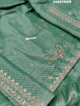 A green Banarsi silk saree with Bollywood style embellishments including sequins and gotapatti work