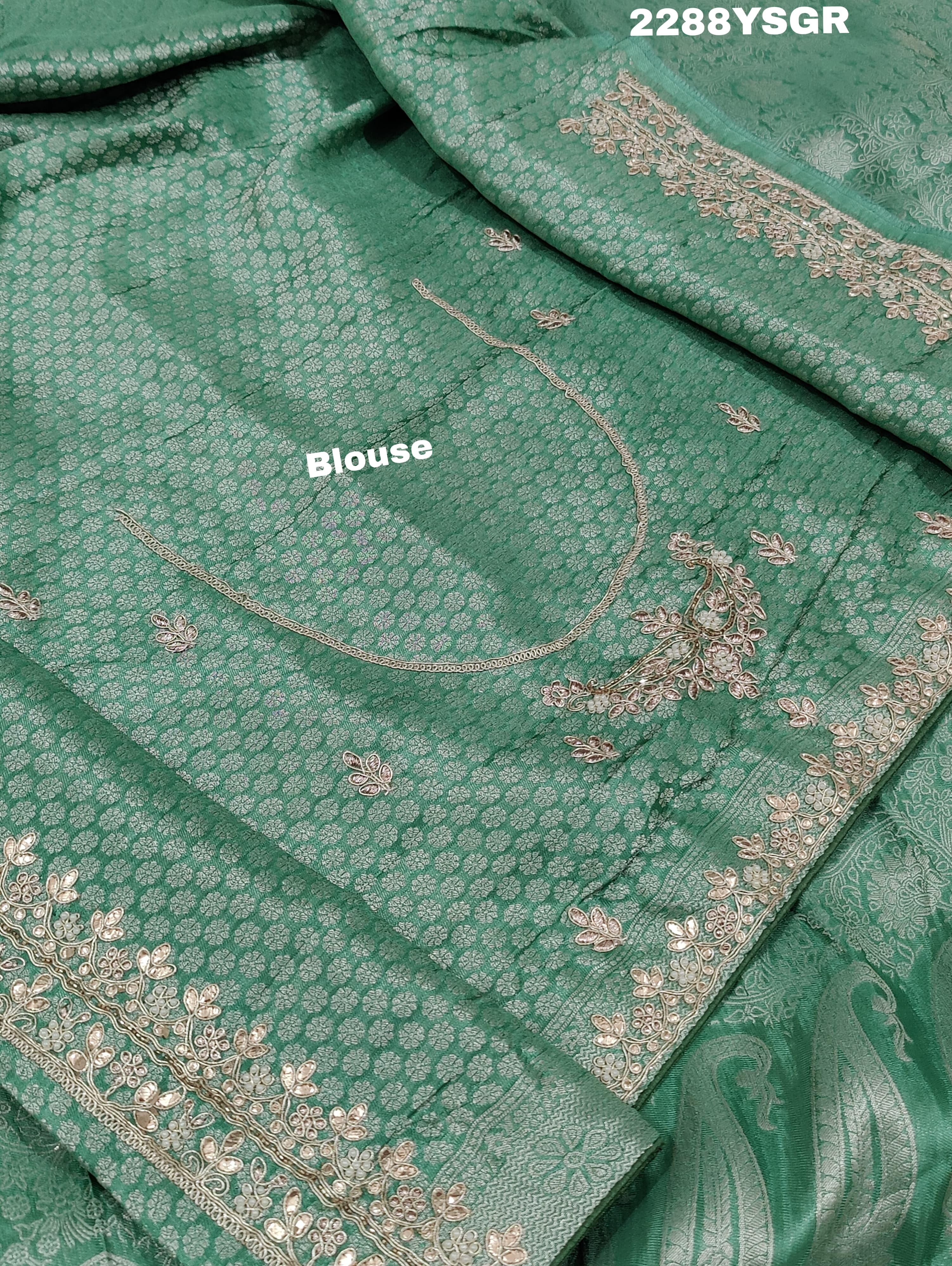 A green Banarsi silk saree with Bollywood style embellishments including sequins and gotapatti work