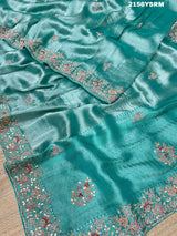 A sea green tissue silk saree with sequence embroidery work in a Bollywood style pattern.