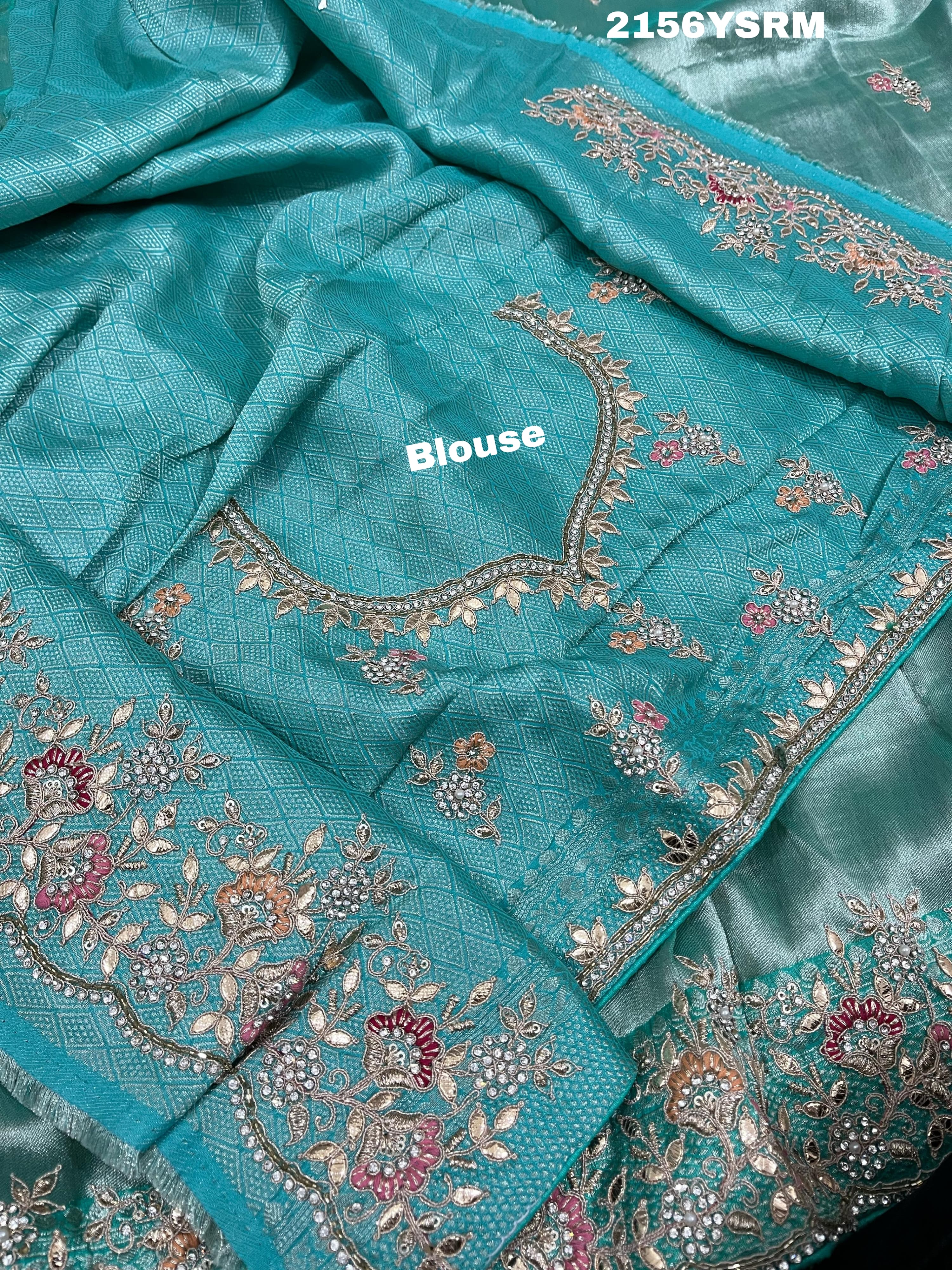 A sea green tissue silk saree with sequence embroidery work in a Bollywood style pattern.