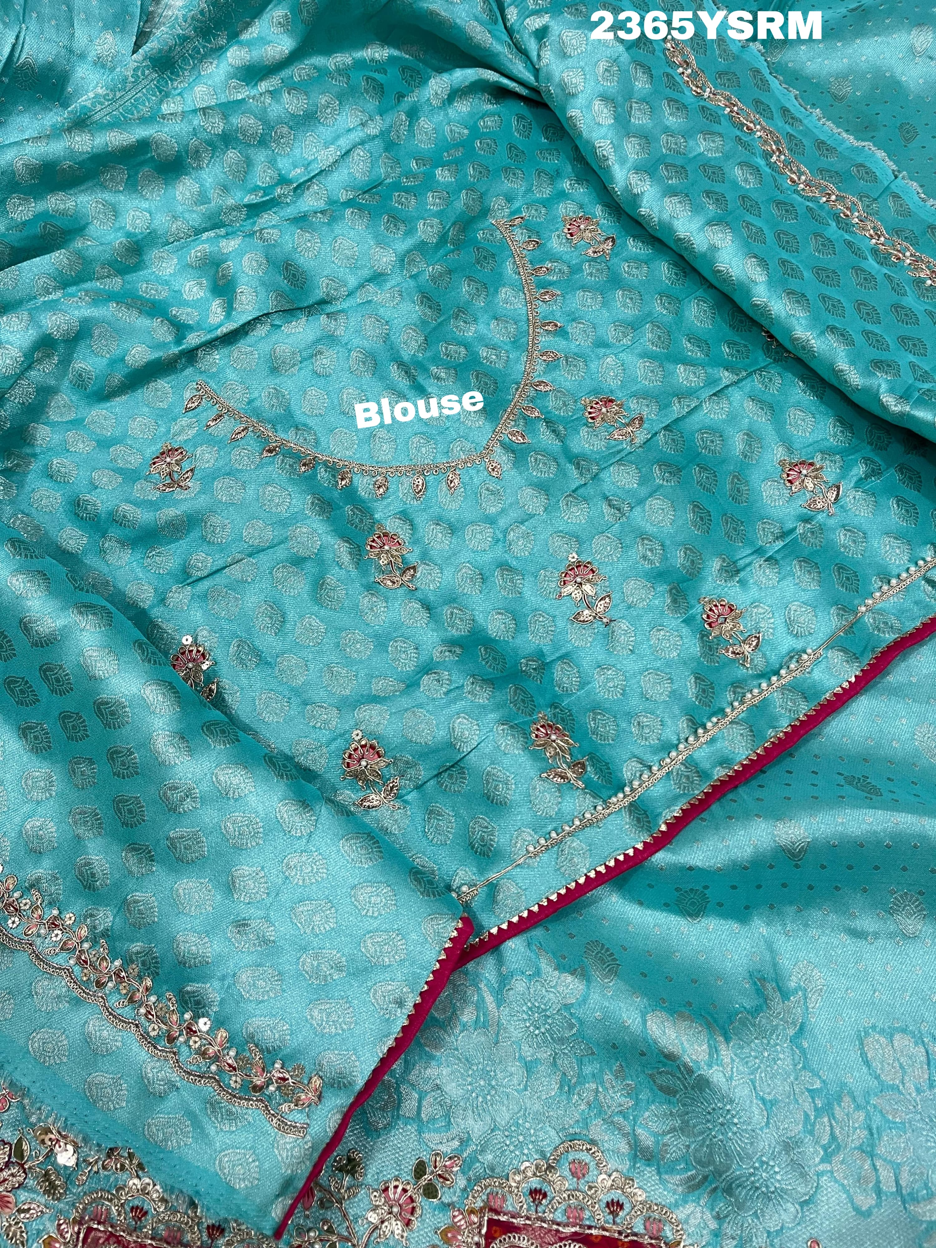 A sea green Banarasi silk saree with sequence embroidery work in a floral pattern and a border featuring a combination of sequins and beads.