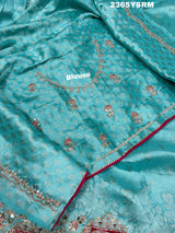 A sea green Banarasi silk saree with sequence embroidery work in a floral pattern and a border featuring a combination of sequins and beads.