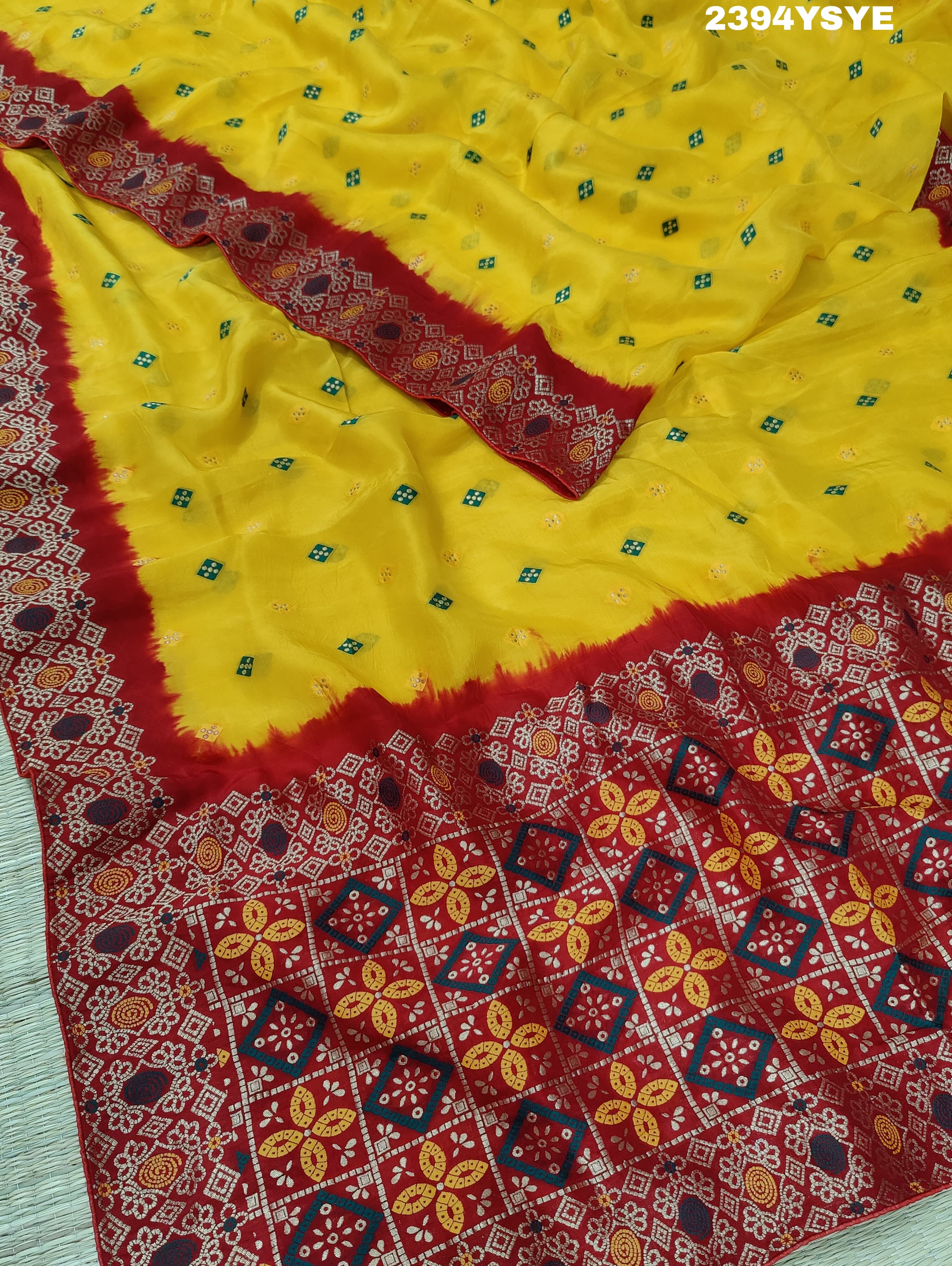 A yellow and red Dola silk saree with Zari weaving and a floral pattern,