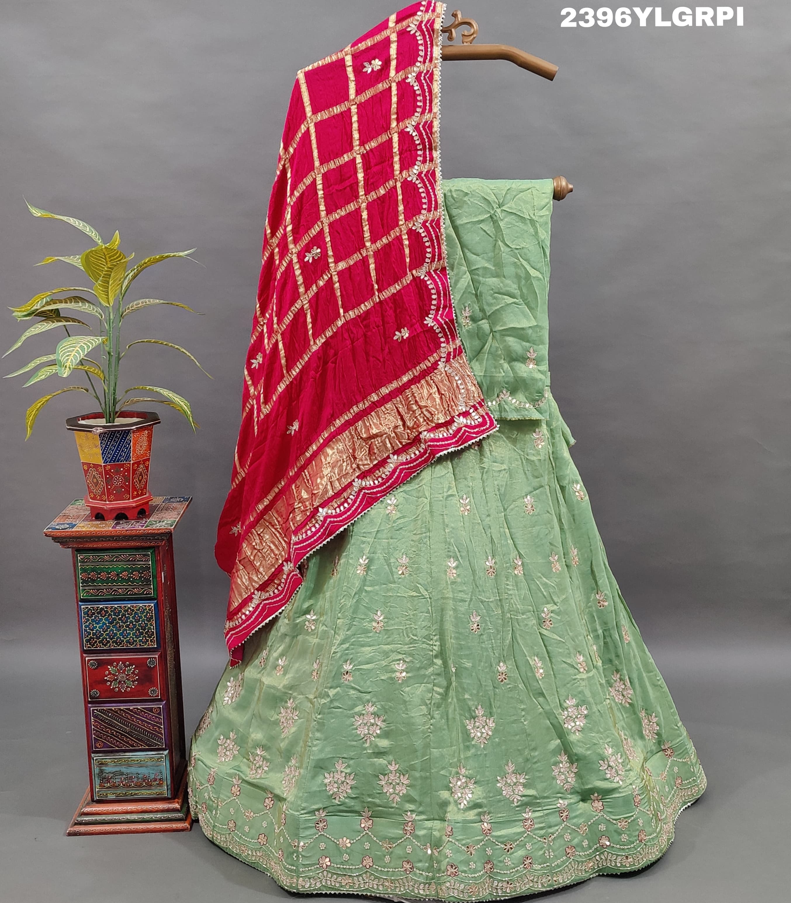 A pista Lehenga with pink gota patti work and a red dupatta