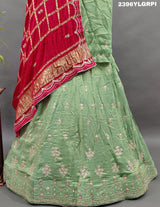 A pista Lehenga with pink gota patti work and a red dupatta