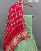 A pista Lehenga with pink gota patti work and a red dupatta