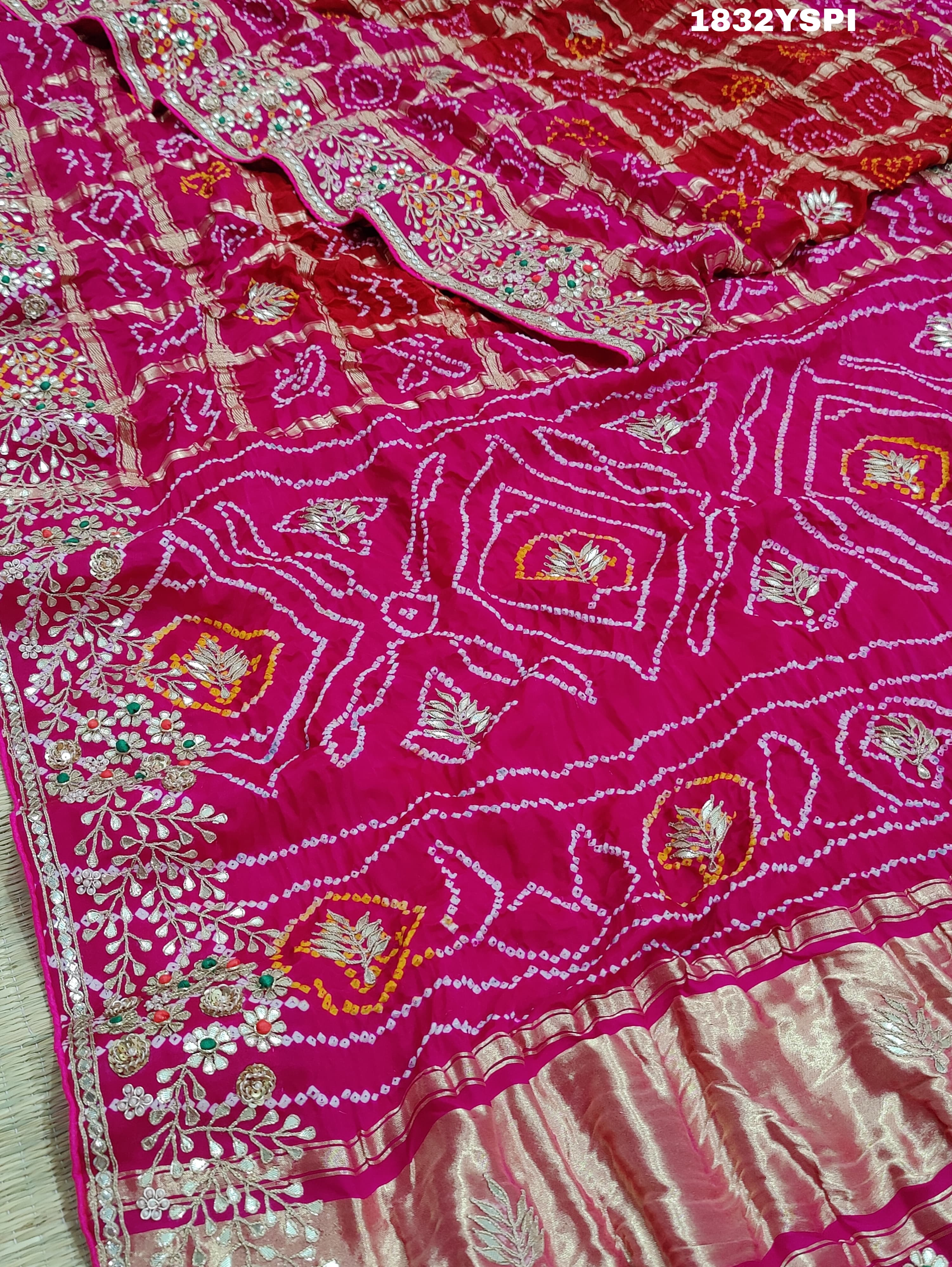 A pink saree with bandhani and gotapatti work, including intricate patterns and embellishments.