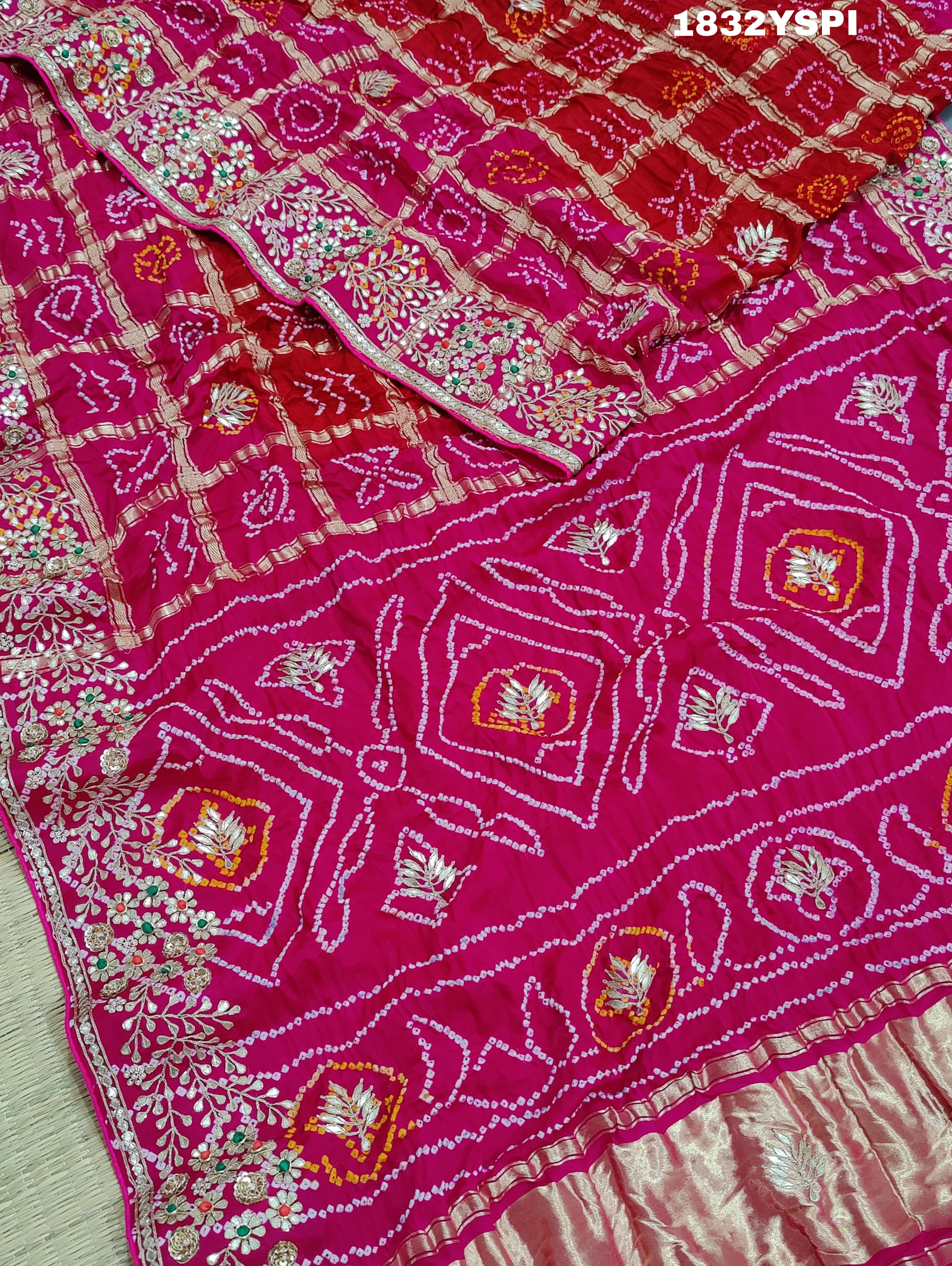 A pink saree with bandhani and gotapatti work, including intricate patterns and embellishments.