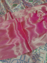 Banarasi silk saree with a printed floral pattern in pink and silver colors, showing detail and texture.