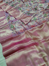Banarasi silk saree with a printed floral pattern in pink and silver colors, showing detail and texture.