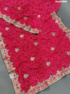 A pink chiffon saree with bandhani pattern and gotapatti work
