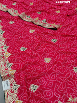 A pink chiffon saree with bandhani pattern and gotapatti work