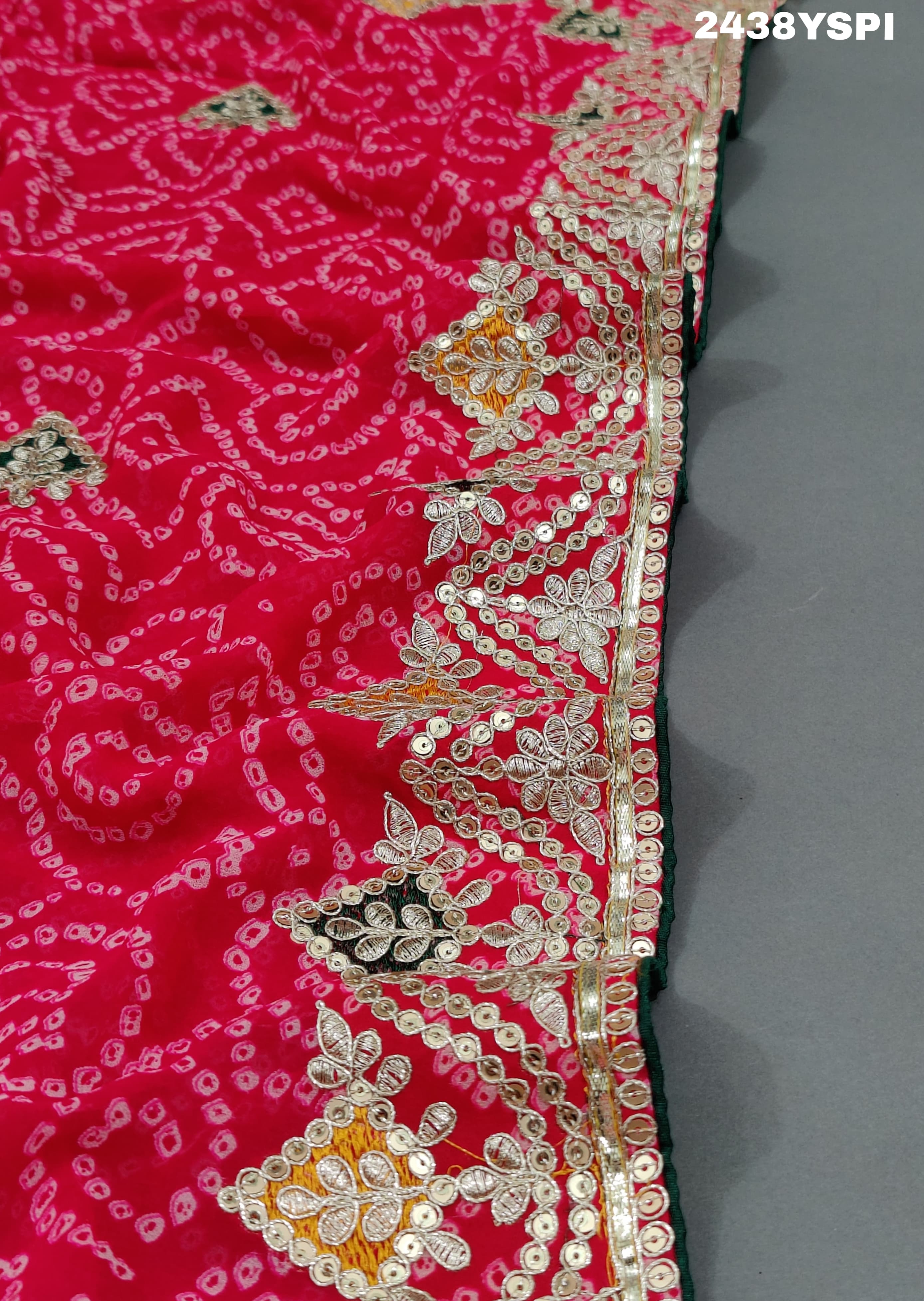 A pink chiffon saree with bandhani pattern and gotapatti work