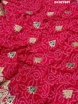 A pink chiffon saree with bandhani pattern and gotapatti work