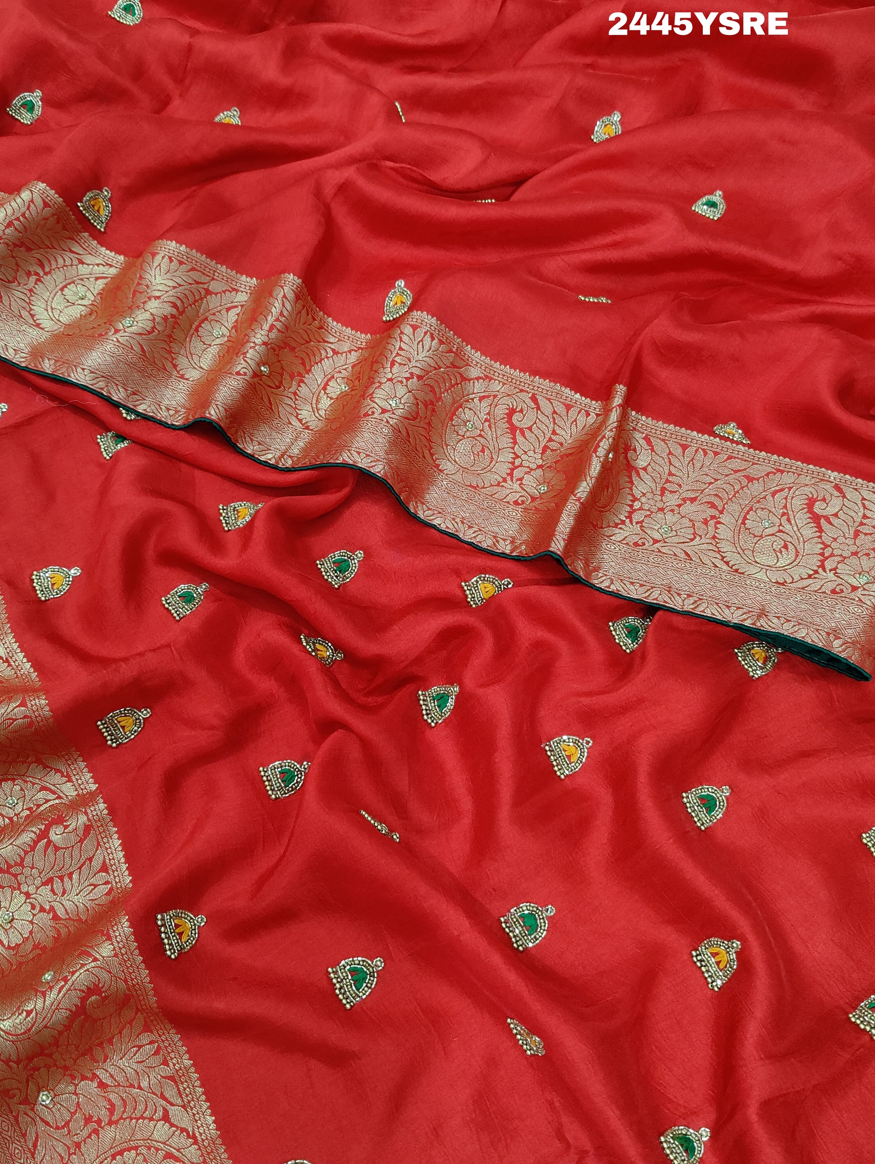 A red Banarasi silk saree with cutdana work and a golden border,